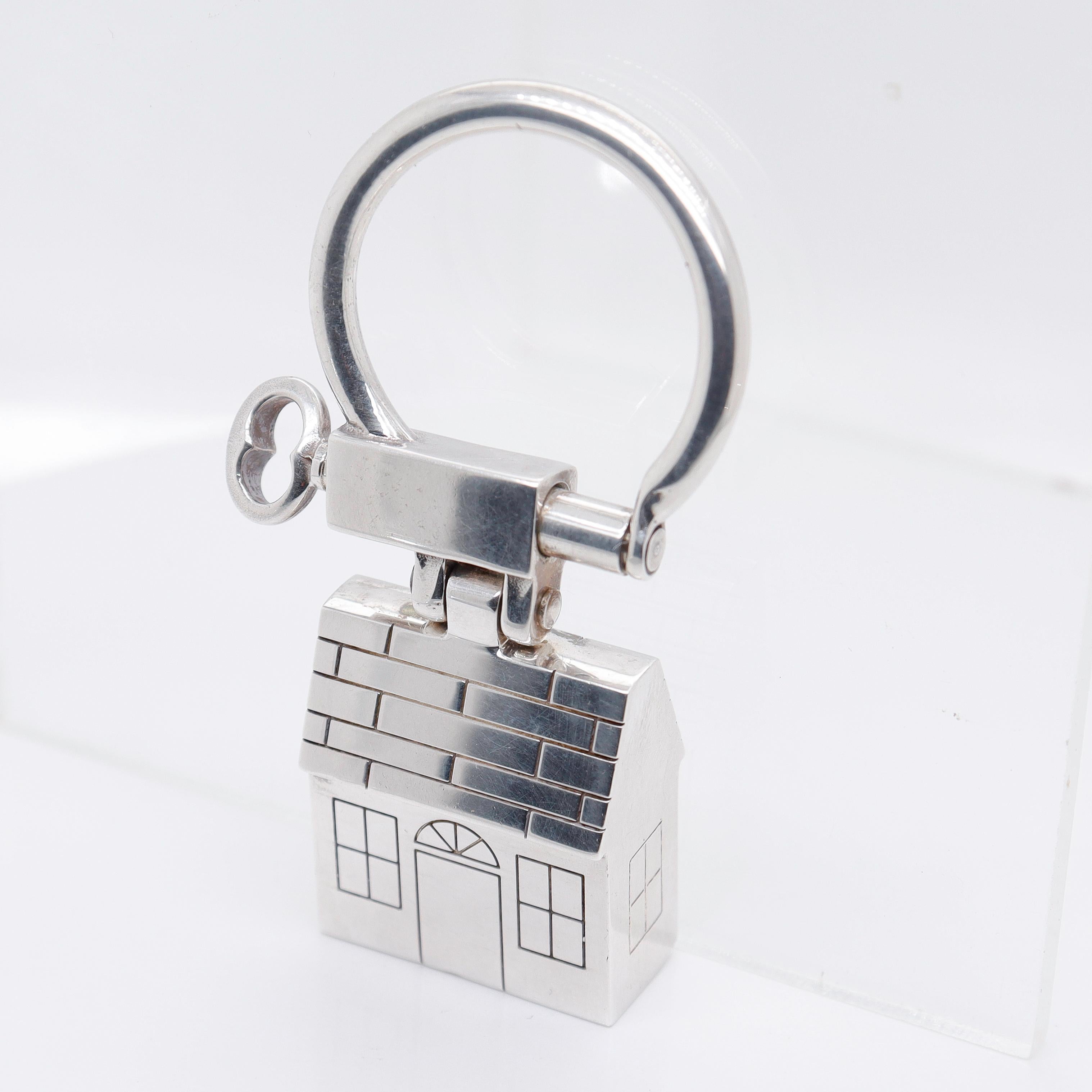 A fine silver key ring or key holder.

In sterling silver.

By Tiffany & Co.

In the form of a house.

Simply a wonderful key ring or holder from Tiffany!

Date:
ca. 1990s

Overall Condition:
It is in overall good, as-pictured, used estate condition