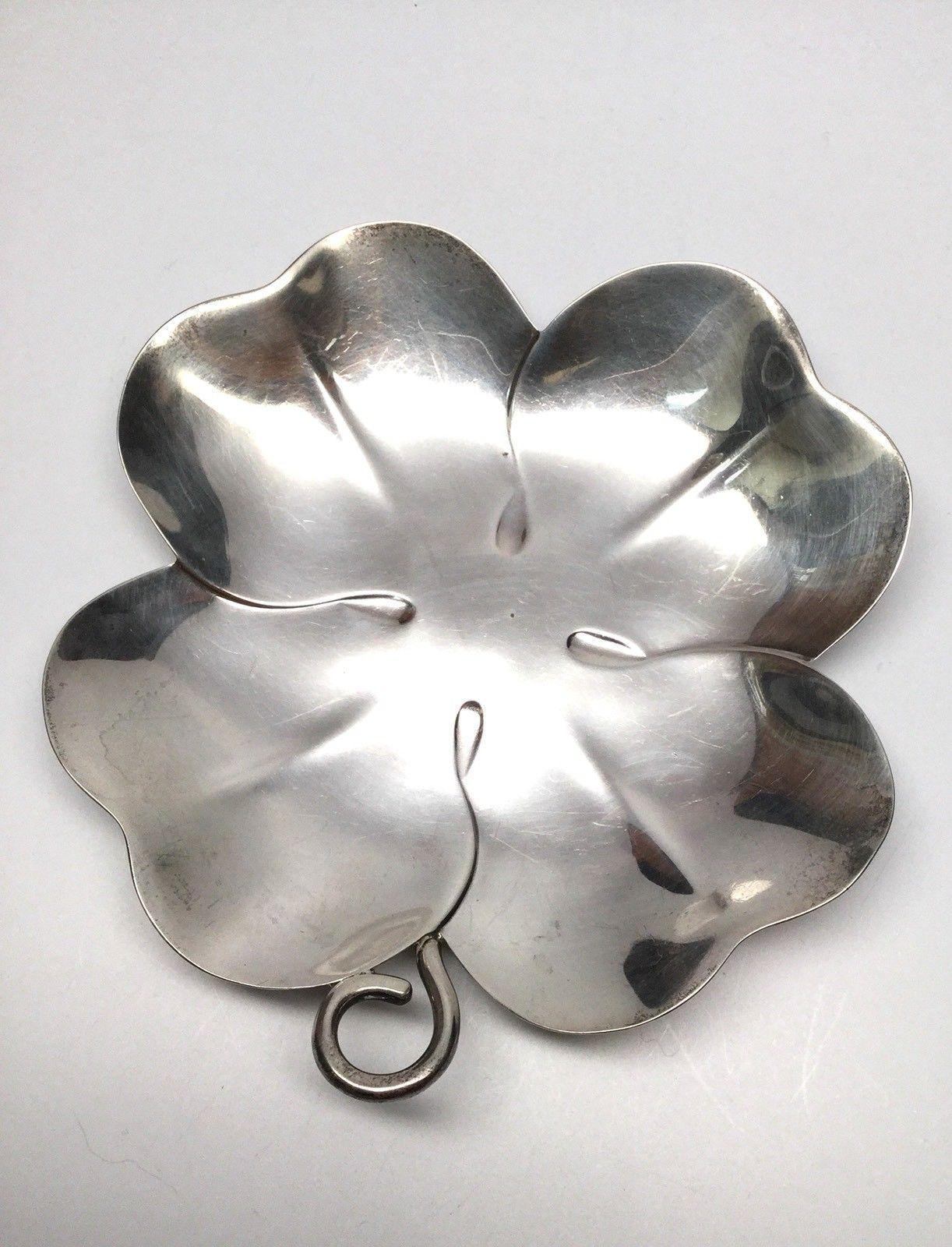 Tiffany & Co. sterling silver four leaf clover shamrock dish. This listing is for a lovely sterling silver four-leaf clover or shamrock shaped bowl/dish #23208 M made by Tiffany & Co. This bowl has a simple elegant design shamrock design.