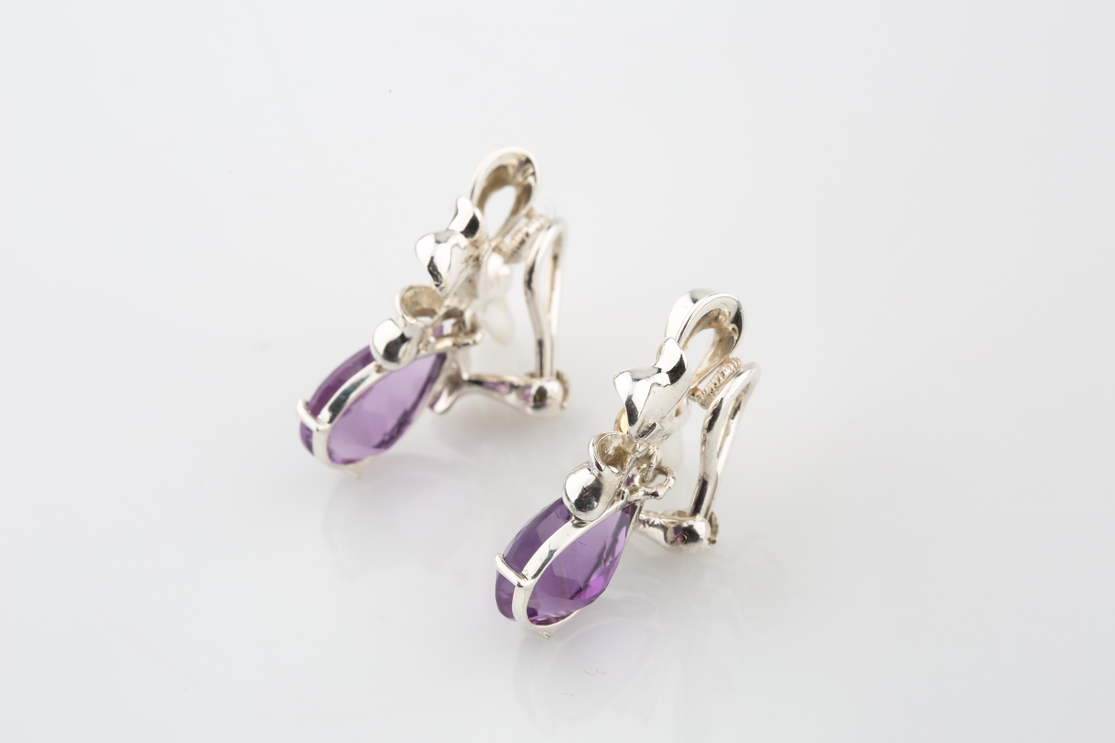 Authentic Tiffany & Co. amethyst bow earrings
Sterling silver bows with a yellow gold center
A large sparkling purple amethyst hangs from each earring
Omega back fastening system
Metal: 925 sterling silver and yellow gold
Hallmarks: TIFFANY&CO.925 