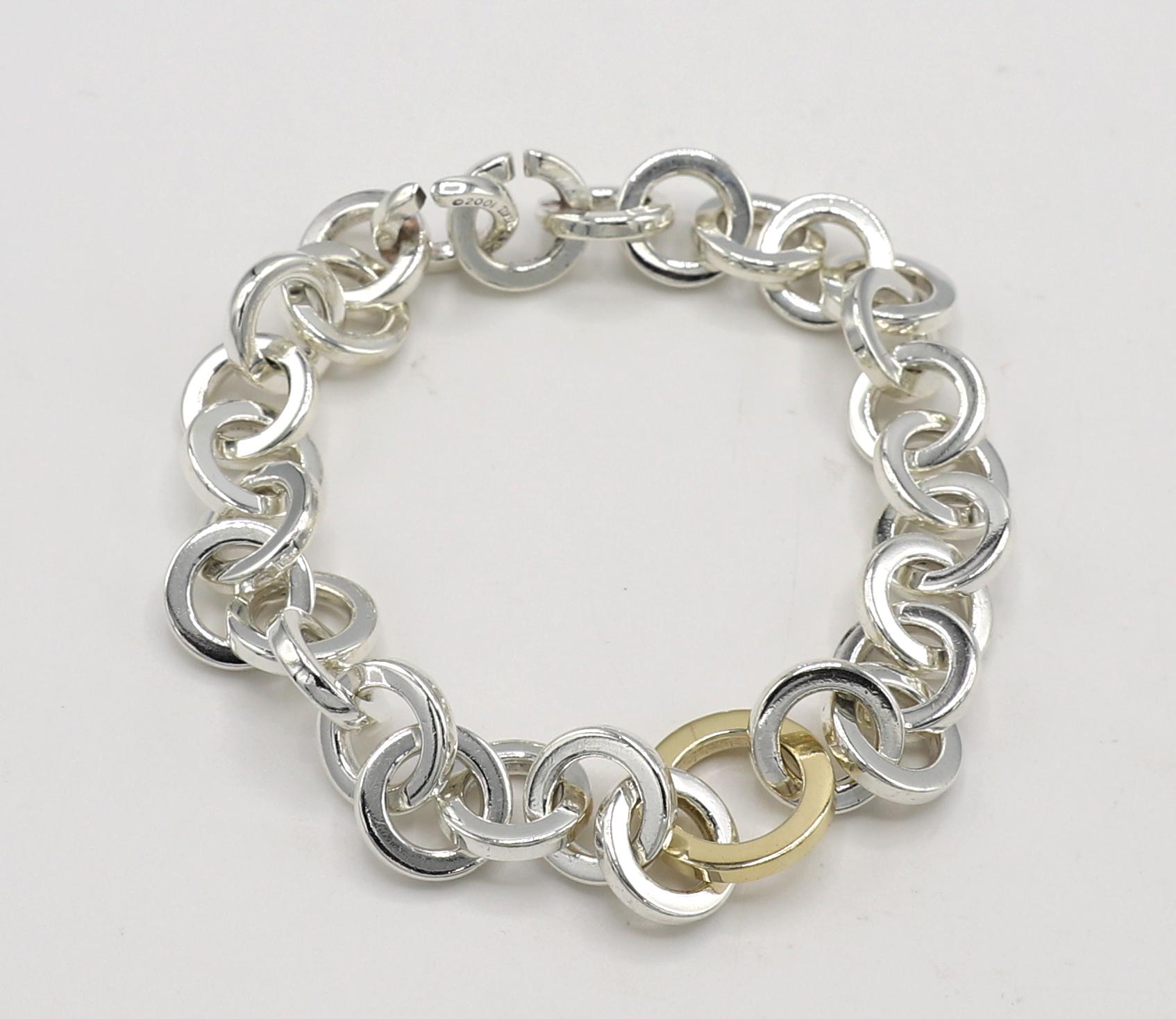 Tiffany & Co. Sterling Silver & Gold Circle Link Bracelet 2001 
Metal: Sterling silver & 18k yellow gold
Weight: 40.8 grams
Length: 8.25 inches
Links: 11.5mm, center gold link 14.5mm
Signed: Tiffany & Co. 2001 925
