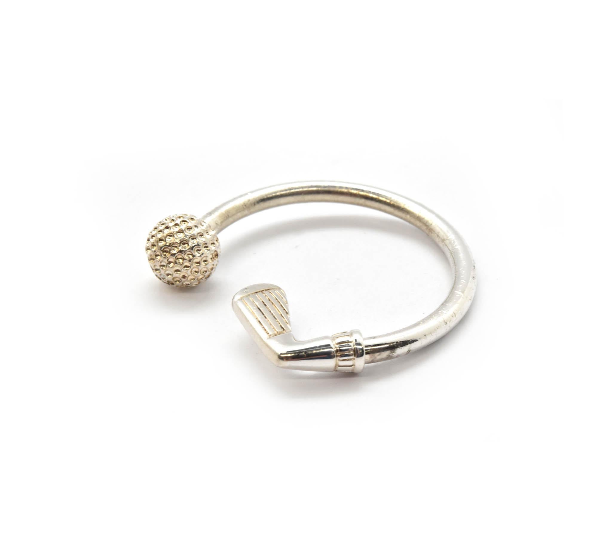 This is an authentic Tiffany & Co sterling silver golf ball key chain! The key chain measures 1.5 inches in diameter. Hallmarked on the side of the key ring is “Tiffany & Co” and “.925.” This would be the ideal gift for someone who loves Tiffany &