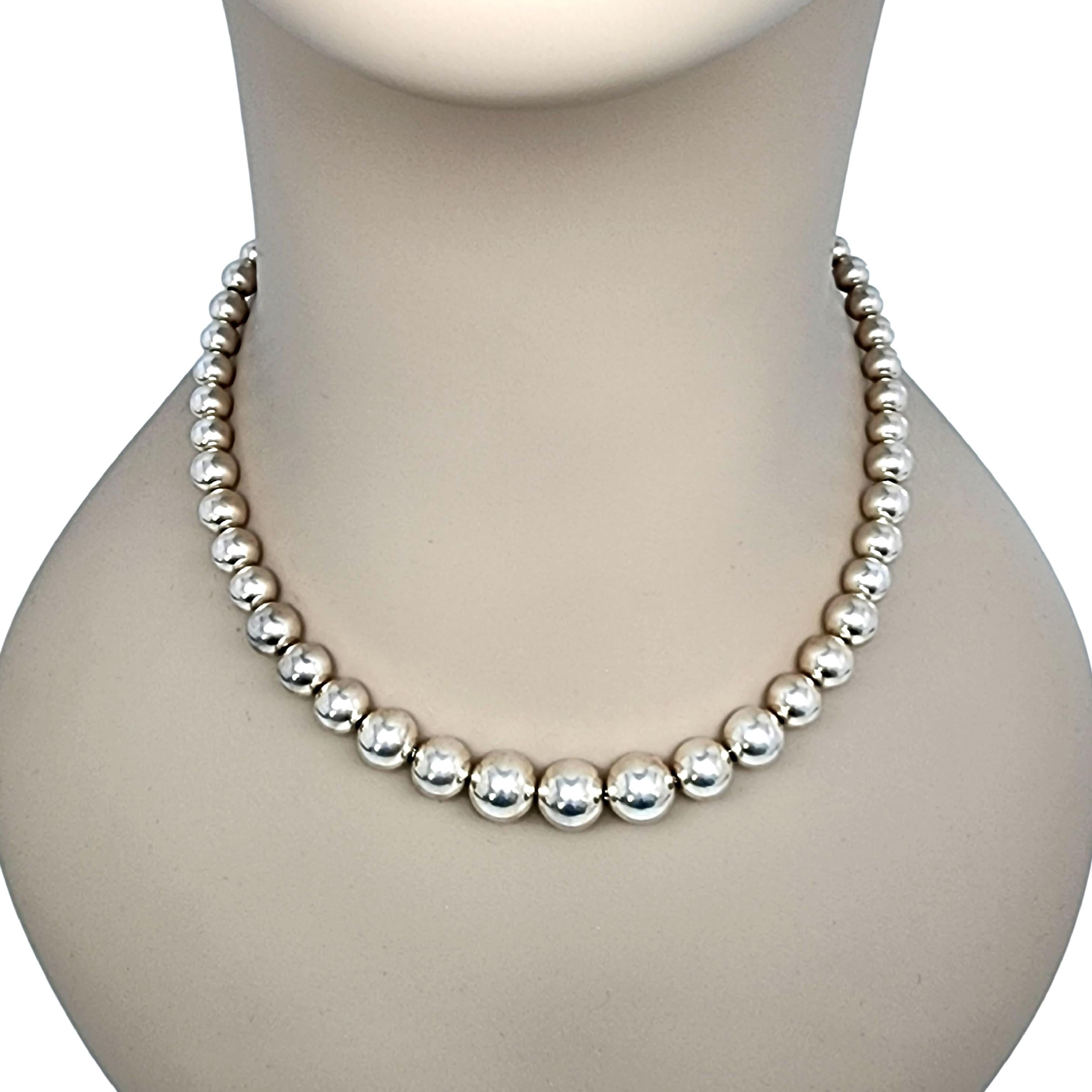 Sterling silver graduated bead/ball necklace by Tiffany & Co.

Authentic Tiffany ball bracelet featuring larger balls at the center graduating to smaller balls closer to the ends. Lobster claw closure. Tiffany box and pouch not included.

Measures