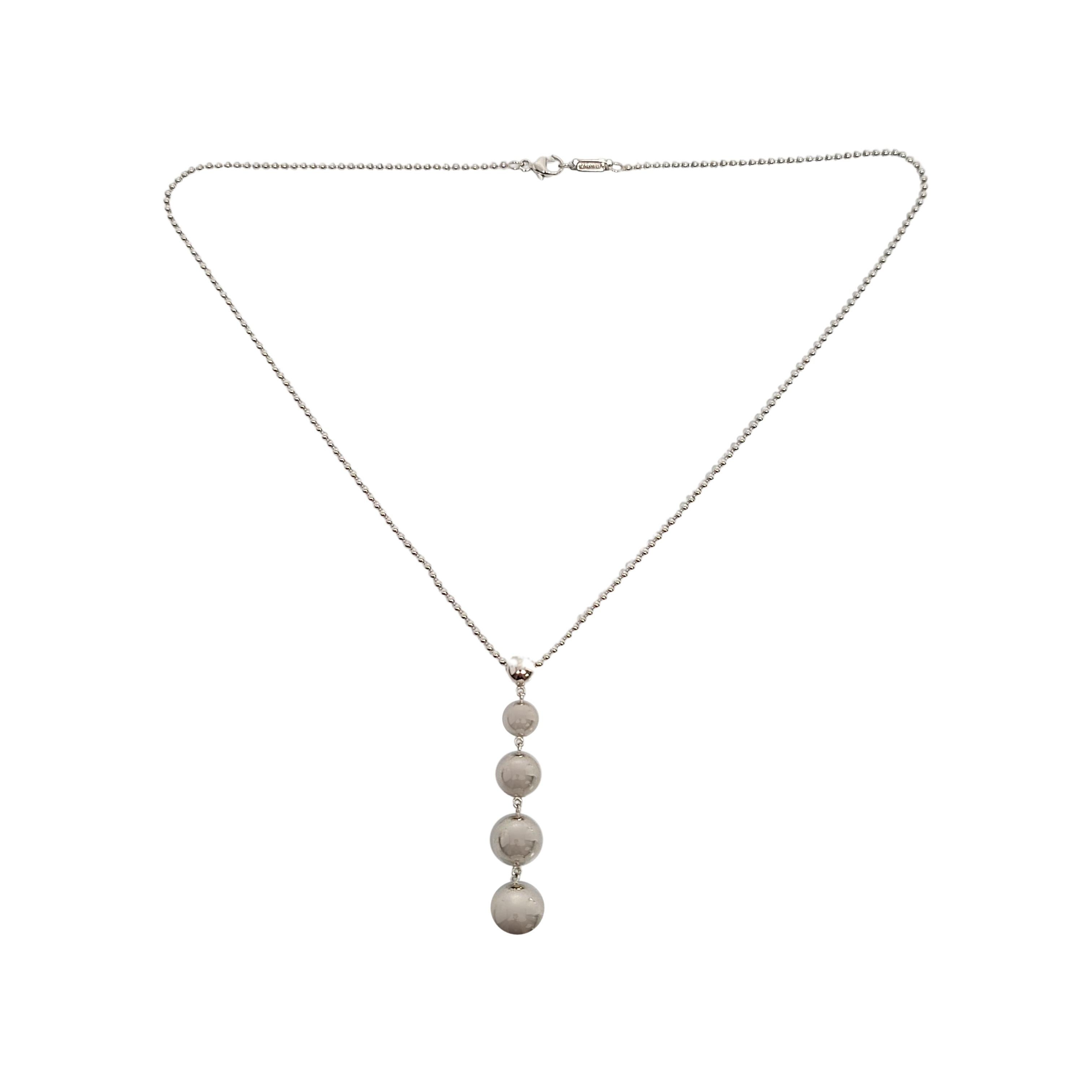 Tiffany & Co sterling silver graduated bead necklace.

An authentic Tiffany & Co necklace featuring a dangle of 5 graduated silver beads on a delicate ball chain. Tiffany box or pouch not included.

Chain measures approx 16