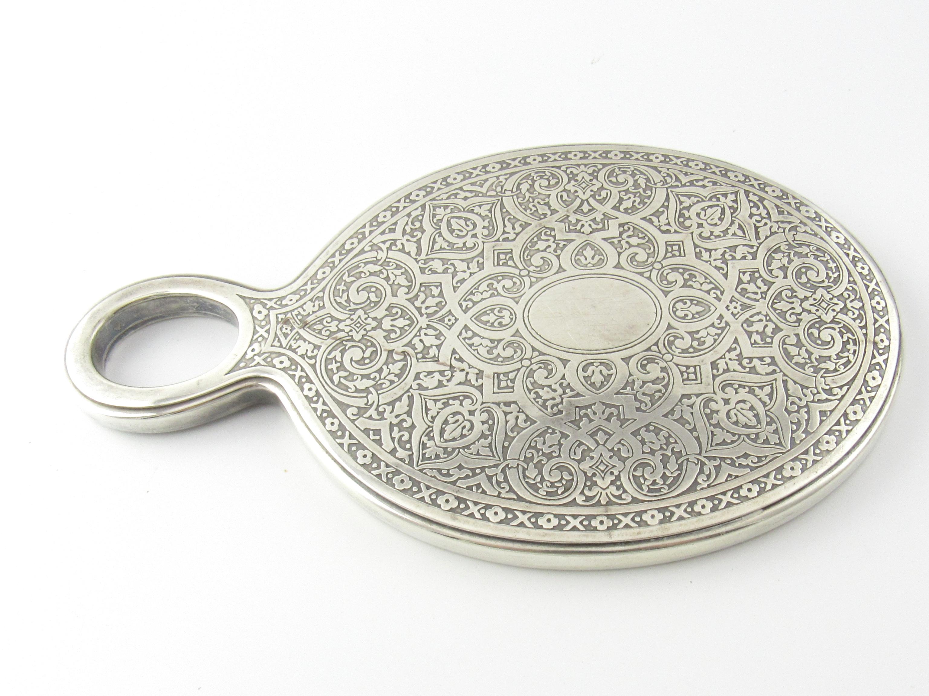 Tiffany & Co Sterling Silver Hand Held Mirror Early 1900's

This is a gorgeous sterling silver hand held mirror with beautiful detail from the early 1900's designed by Tiffany & Co.

Measurement: Measures approx. 8 inches in length and 4 and 3/4