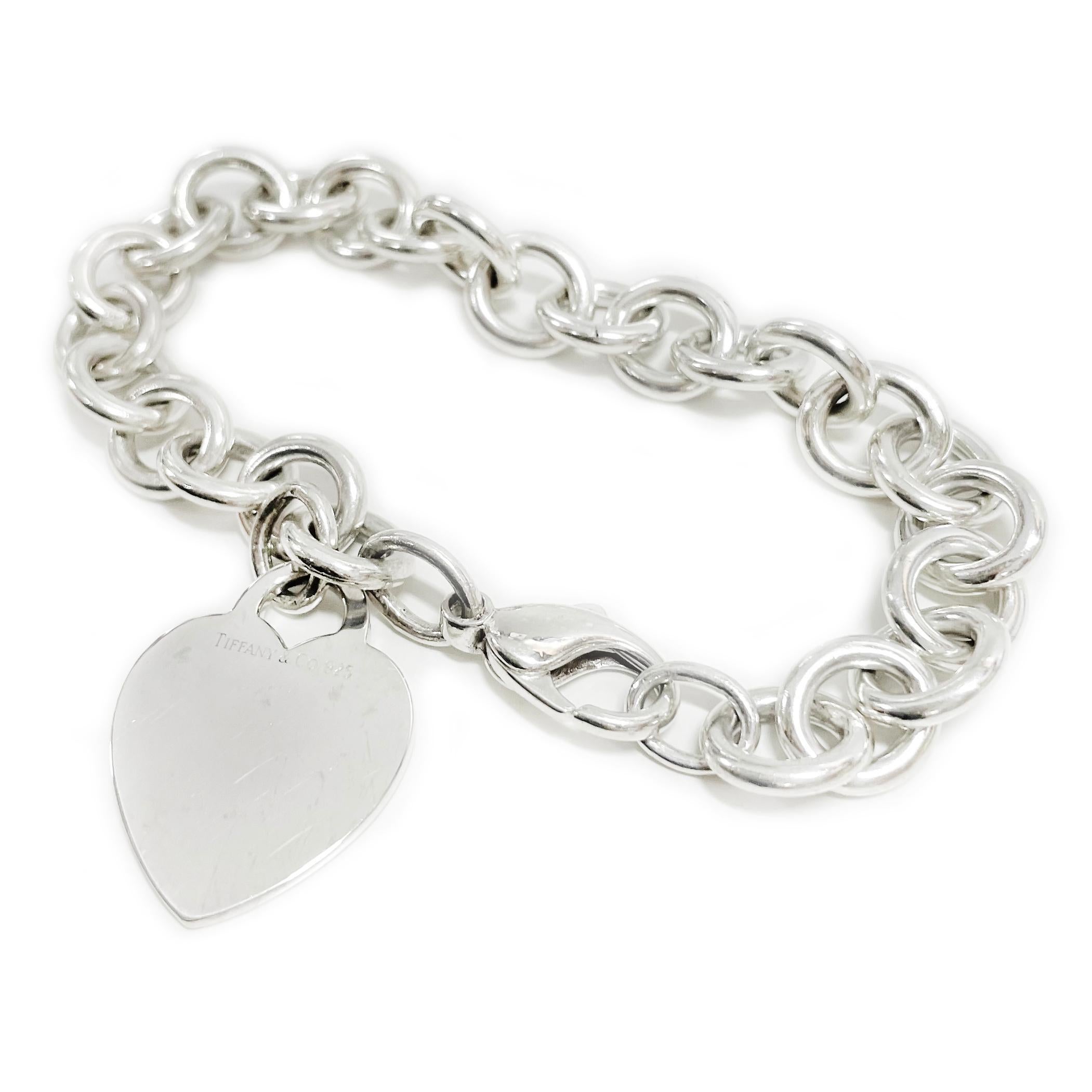 Tiffany & Co. Sterling Silver Heart Bracelet. The bracelet features a heavyweight link chain with a signature Tiffany heart pendant/charm and lobster clasp closure. There are slight surface scuffs but no major scratches. The links measure