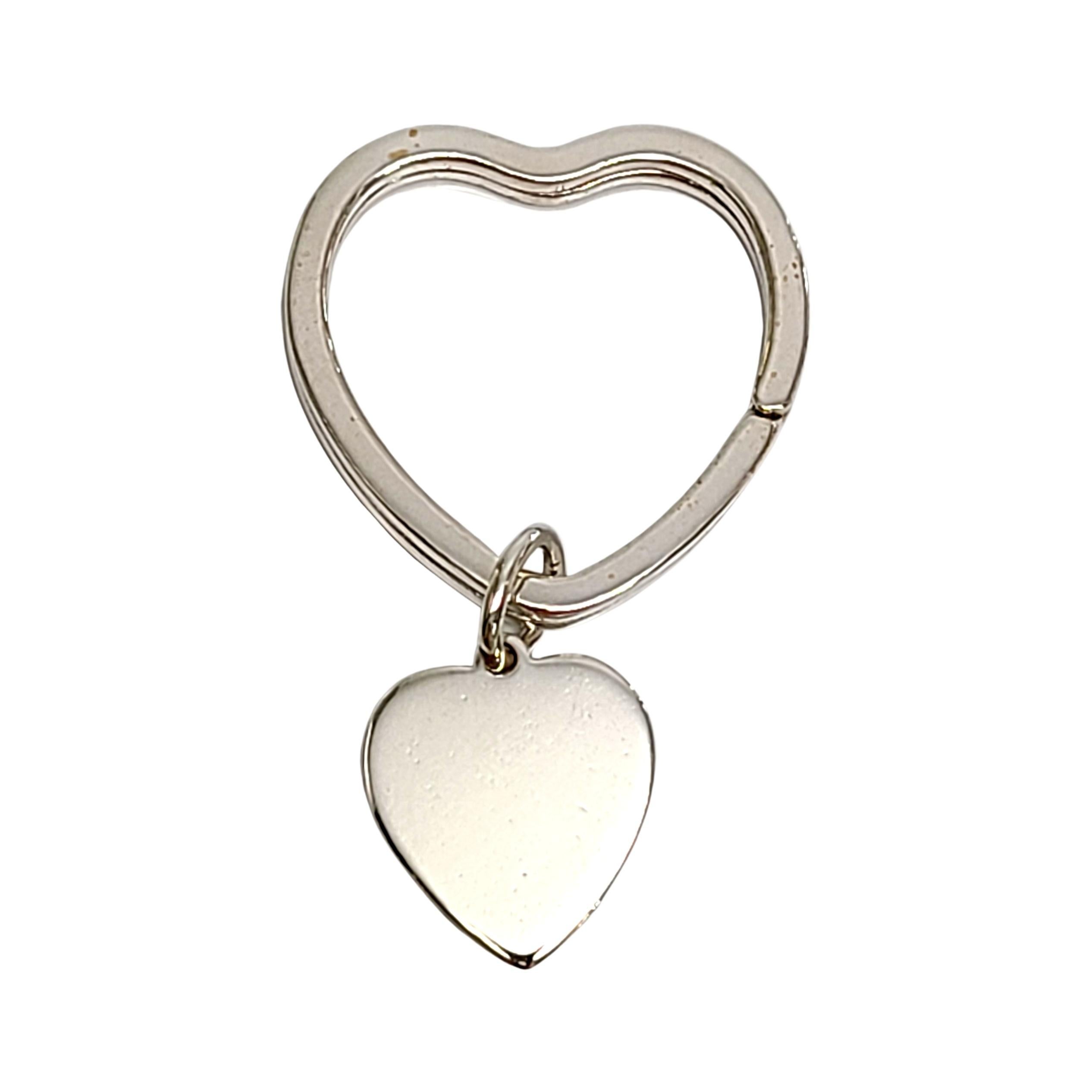 Tiffany & Co sterling silver heart key ring with heart tag.

Authentic Tiffany sterling silver key ring in a heart shape featuring a heart shaped dangling tag. Tiffany pouch and box not included.

Measures approx 2 1/4