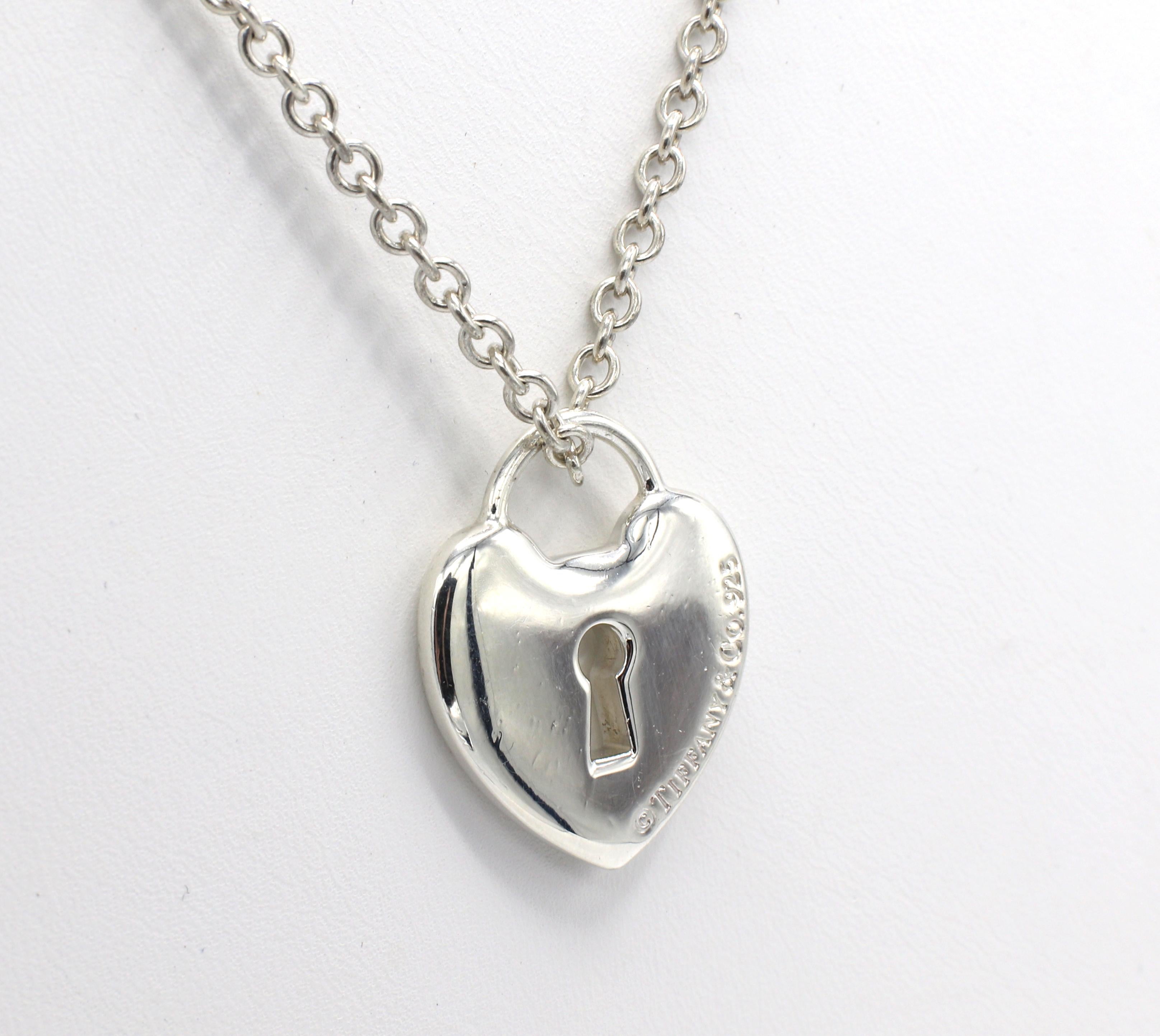 Tiffany & Co. Sterling Silver Heart Lock Pendant Necklace 
Metal: Sterling silver 925
Weight: 18.4 grams
Pendant: 25 x 20mm
Chain length: 24 inches
Chain width: 2.8mm
Signed: Tiffany & Co. 925 
