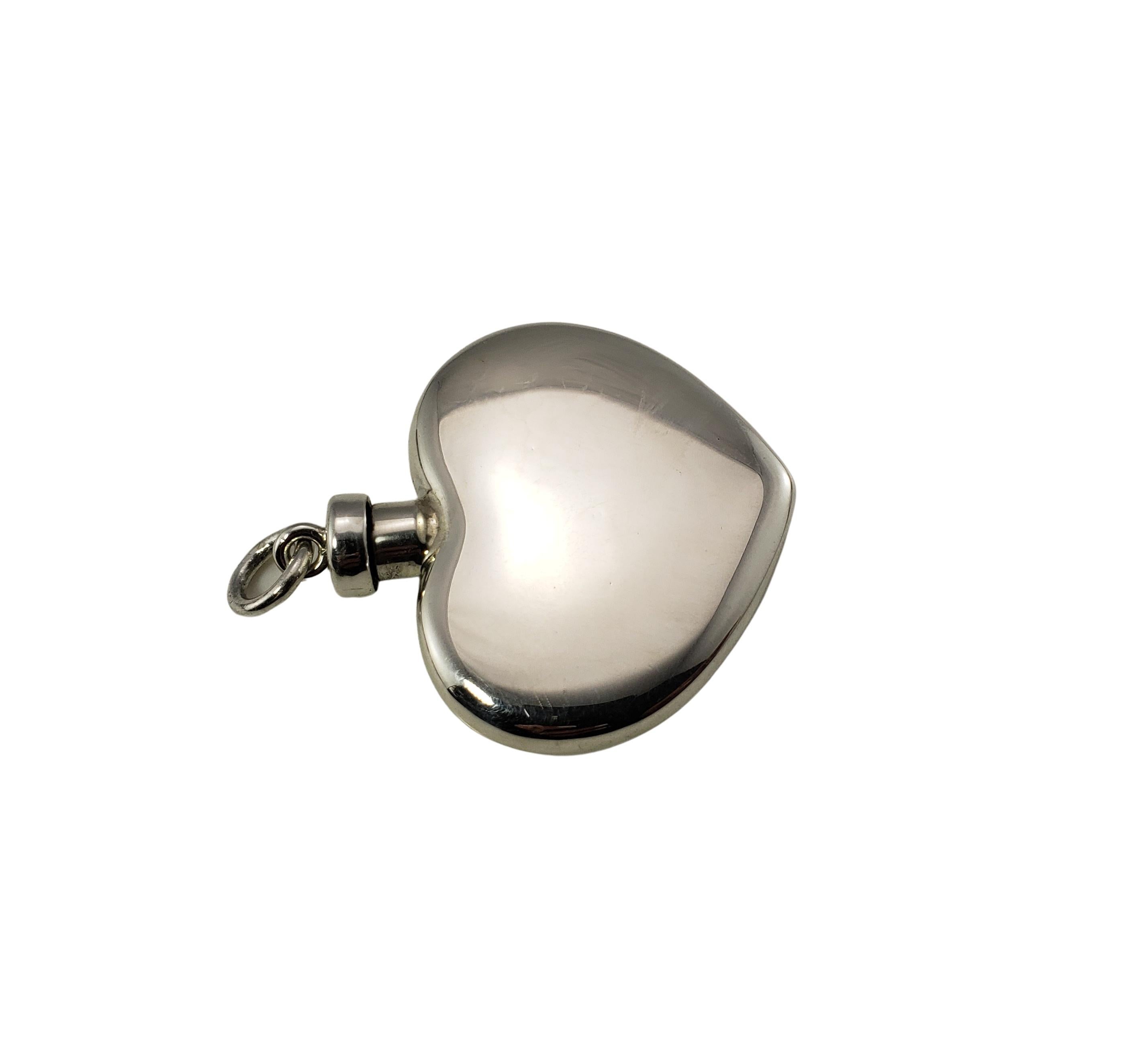 Tiffany & Co. Sterling Silver Perfume Bottle-

This elegant heart perfume bottle by Tiffany & Co. is crafted in beautifully detailed sterling silver.

Size: 46 mm x 42 mm

Weight:  13.1 dwt. /  20.5 gr.

Hallmark:  TIFFANY & CO.  STERLING

Very good
