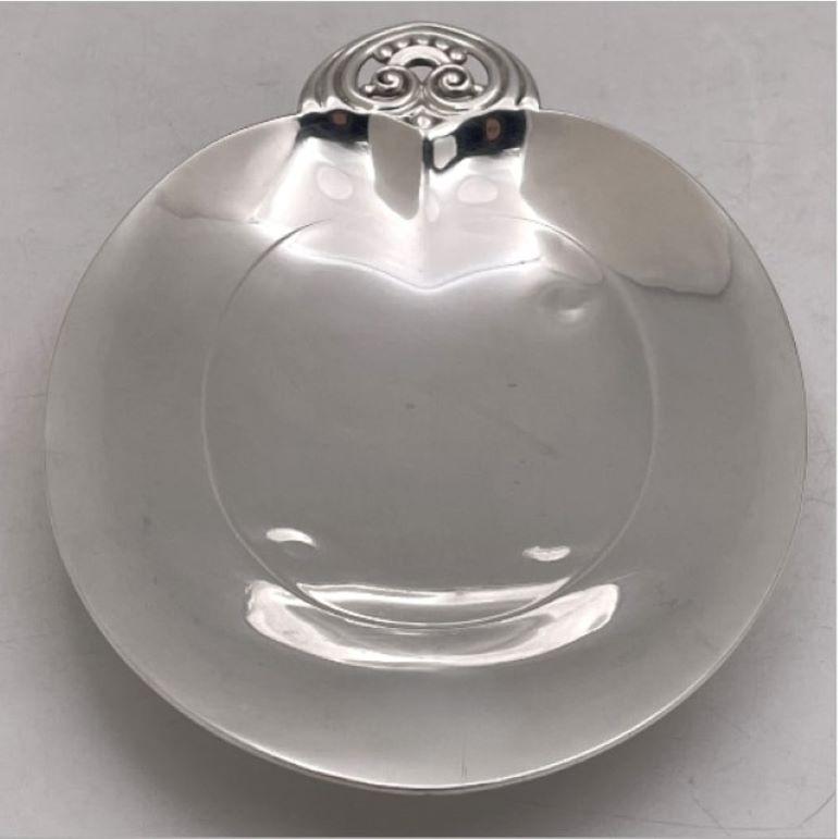 Tiffany & Co. sterling silver heart-shaped dish in pattern number 22898 from 1940 and in Mid-Century Modern Style, with an elegant, geometric design, standing on 4 balled feet. It measures 10 1/2'' in length by 6 7/8'' in width by 1 3/4'' in height,