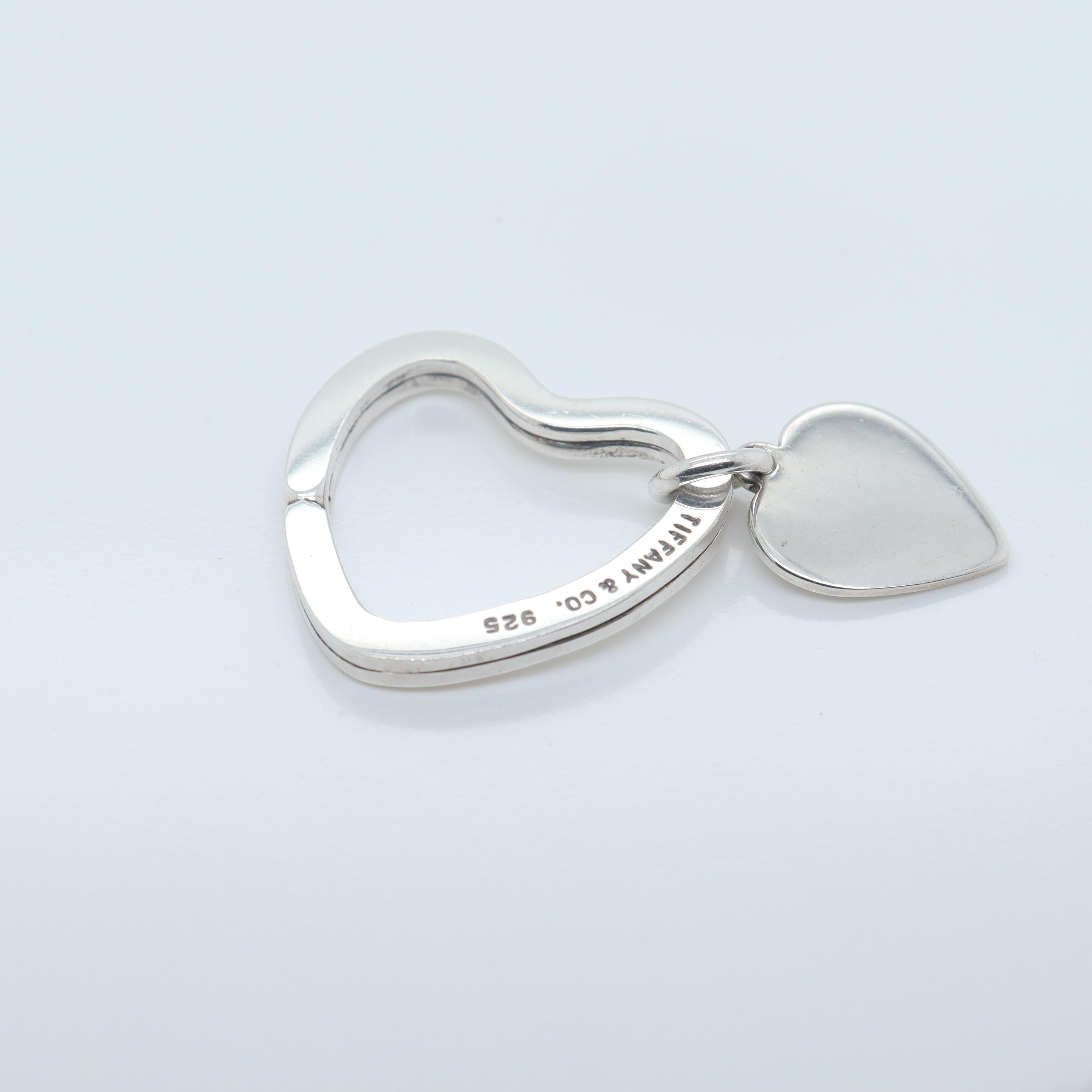 A fine silver heart shaped key holder or ring.

By Tiffany & Co.

In sterling silver.

With a heart pendant or charm attached to the ring.

Simply a wonderful key holder or key ring from Tiffany!

Date:
20th Century

Overall Condition:
It is in
