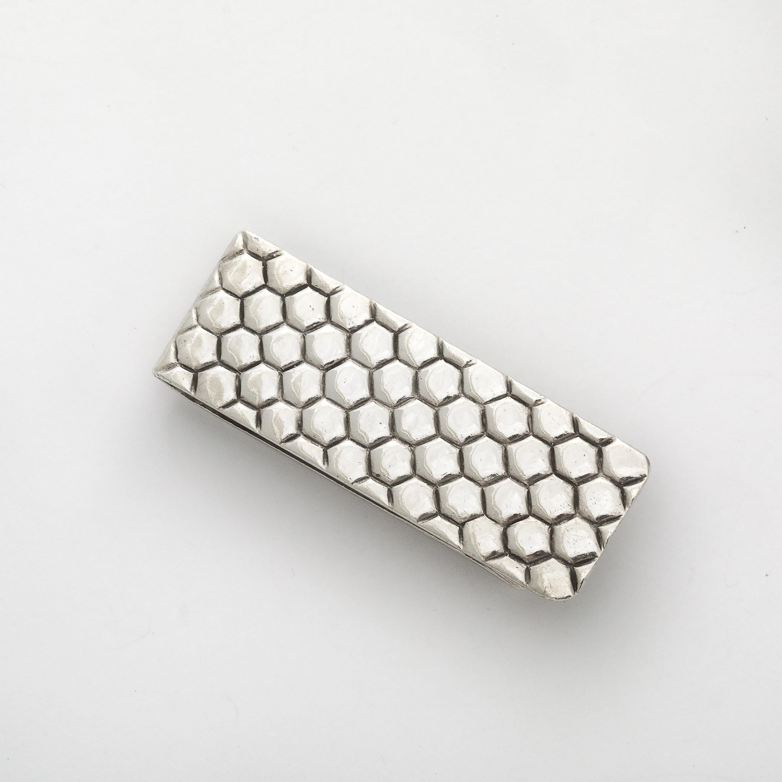 This beautifully formed Tiffany & Co. Sterling Silver Honeycomb Money Clip originates from the United States during the latter half of the 20th Century. The piece features a minimal streamlined form with honey-comb style relief patterning providing