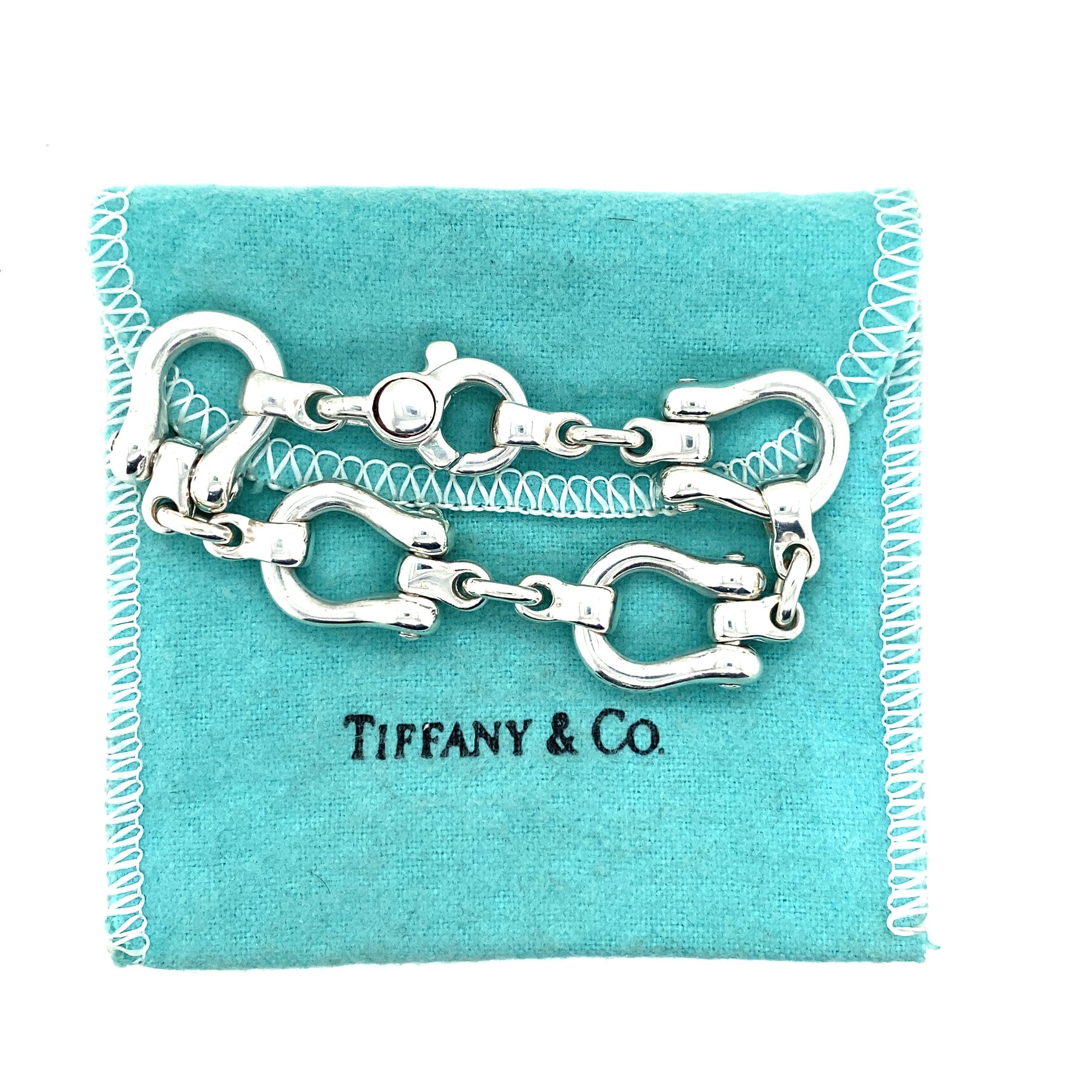 Tiffany & Co. Horseshoe Link Bracelet in Sterling Silver.  The Bracelet measures 6 1/2 inch in length and 5/8 inch in width at the widest point.  44.32 grams.  Signed.  Tiffany & Co. Blue bag included.