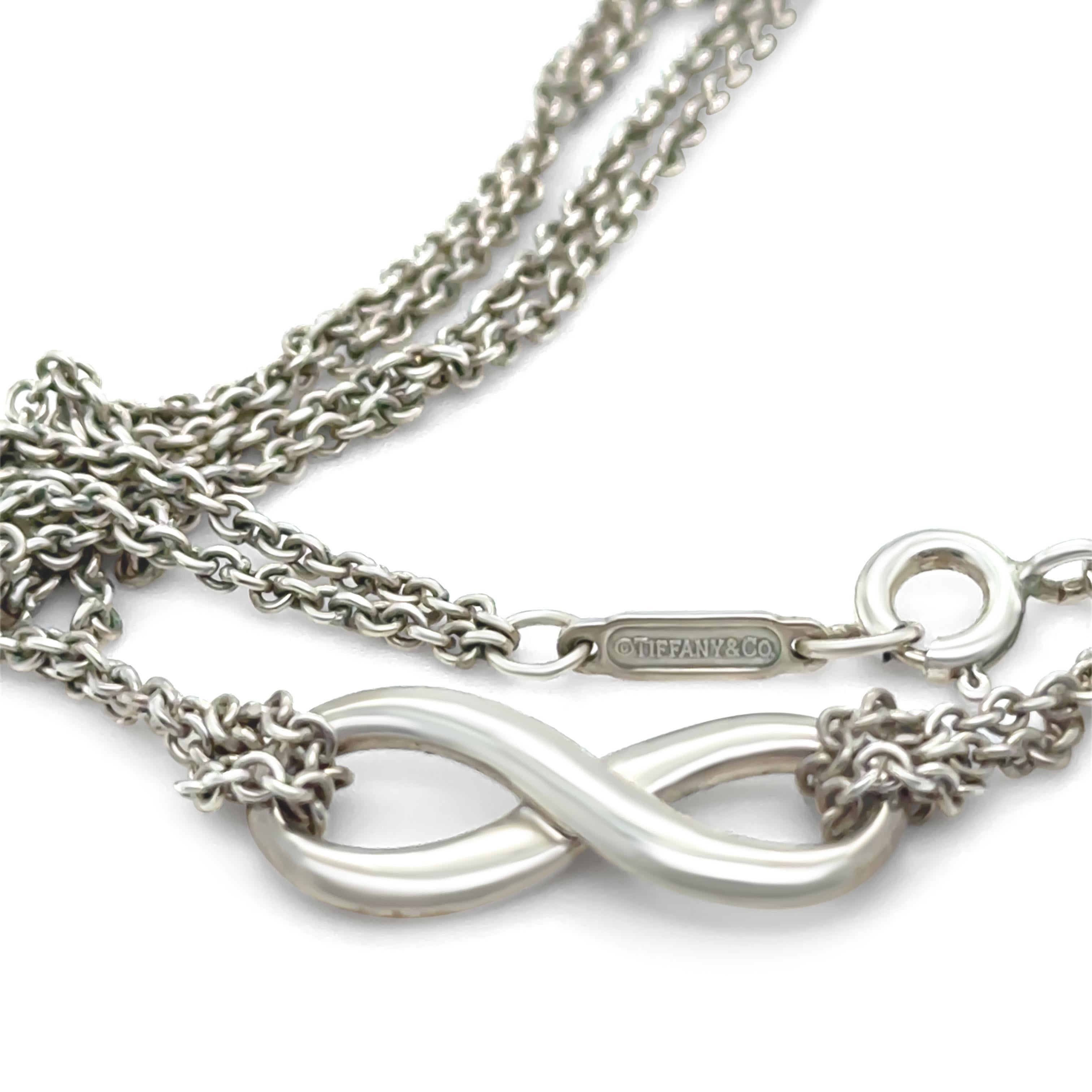 This elegant Tiffany & Co. Infinity pendant necklace is crafted in sterling silver, featuring the timeless infinity symbol - a representation of eternal love and connection. The clean, fluid lines of the pendant are both modern and meaningful,