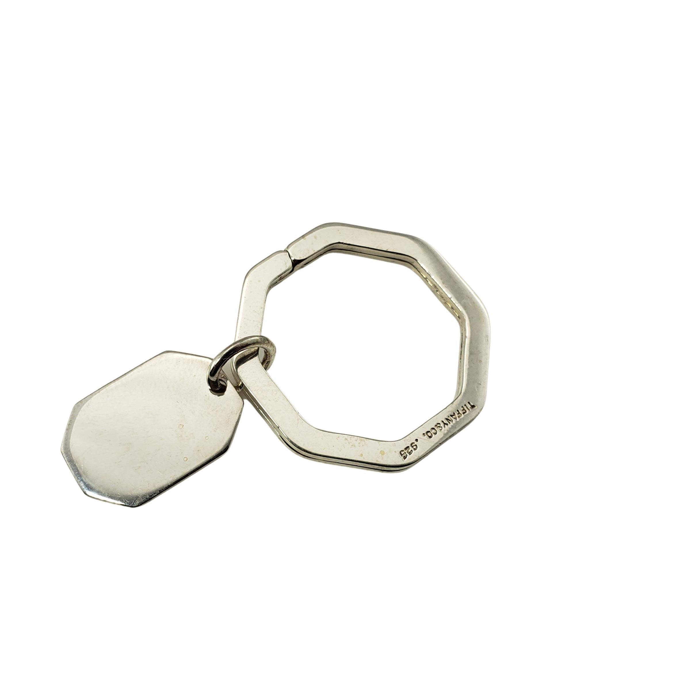 Tiffany & Co. Sterling Silver Key Ring-

This elegant Tiffany & Co. key ring featuring a hanging dog tag is crafted in beautifully detailed sterling silver.

Size:   30 mm (key ring)
           20 mm x 14 mm (dog tag)

Weight:  6.4 dwt. /  10.0