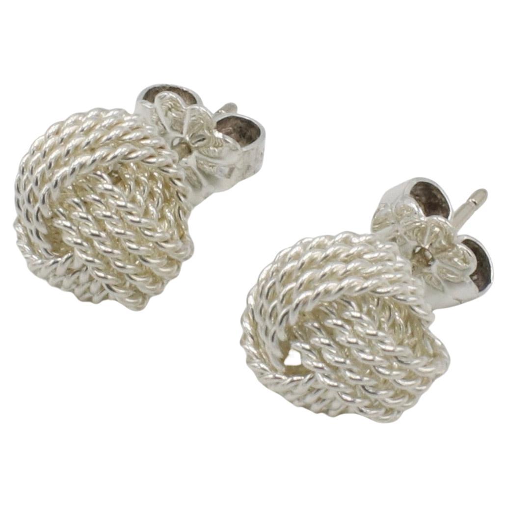 Tiffany & Co. Sterling Silver Knot Rope Stud Earrings 
Metal: Sterling silver 925
Weight: 2.79 grams
Diameter: 9.5mm
Backs: Friction backs (posts)
Retail: $500 USD
RT F35000603