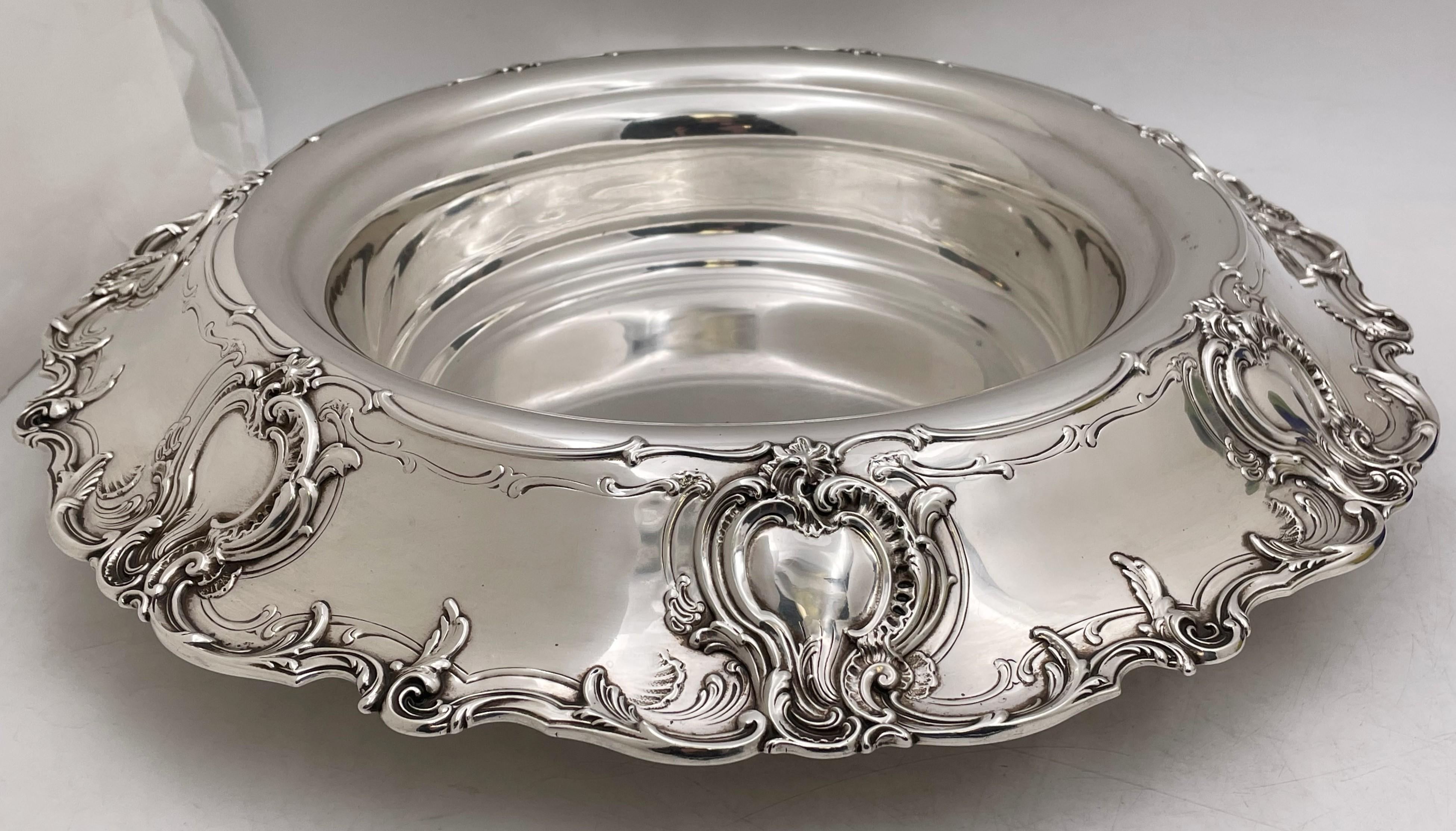 Stunning sterling silver centerpiece bowl by Tiffany & Co. in Kings pattern from 1914. Designed with a turned over rim, decorated with a foliate scroll border and cartouches. Measuring 17” in diameter by 3 ¾” in height and 68 troy ounces. Bearing
