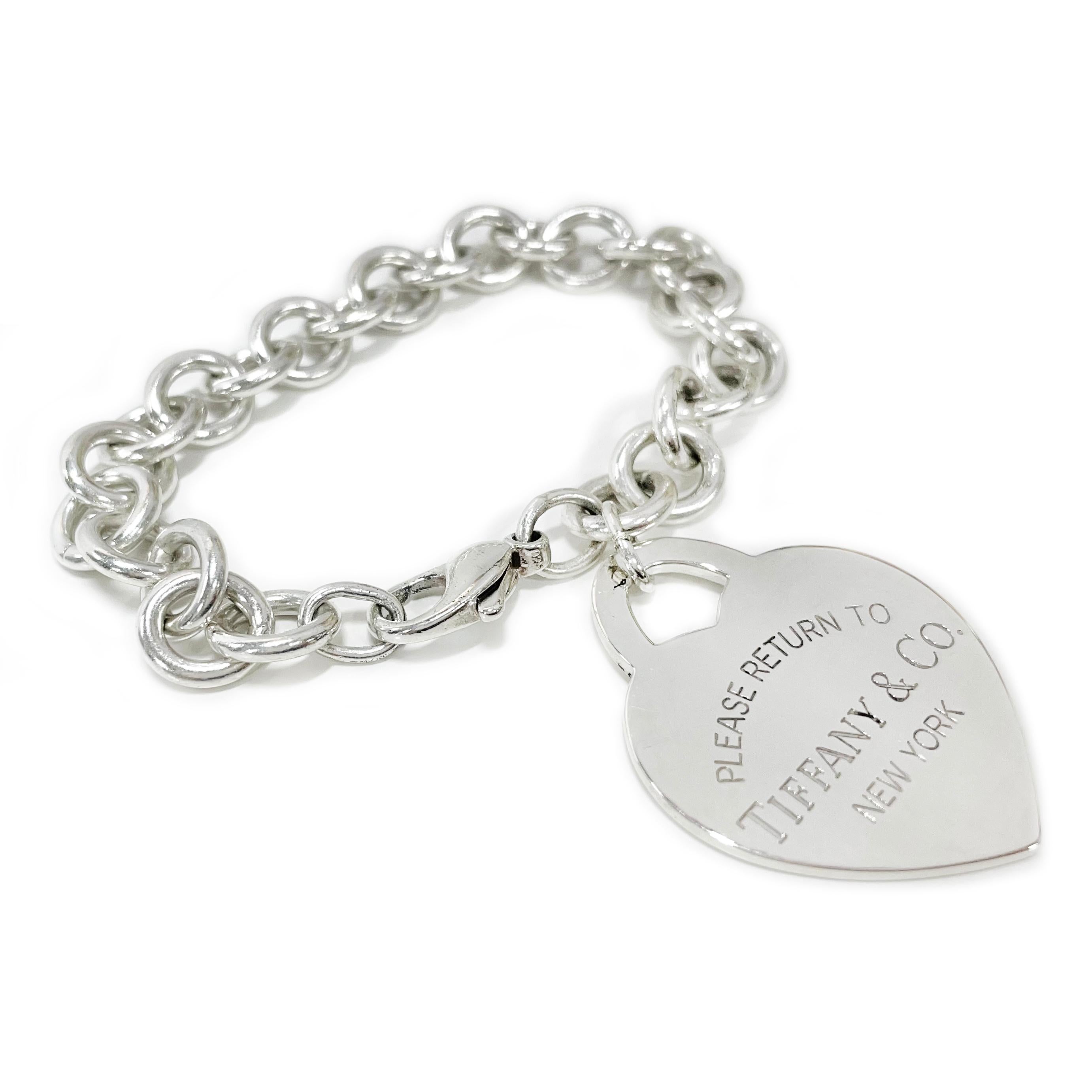 Tiffany & Co. Large Sterling Silver Heart Bracelet. The classic bracelet features a heavyweight link chain with a signature Tiffany heart pendant/charm and lobster clasp closure. Stamped on the front of the heart pendant is Please Return to Tiffany