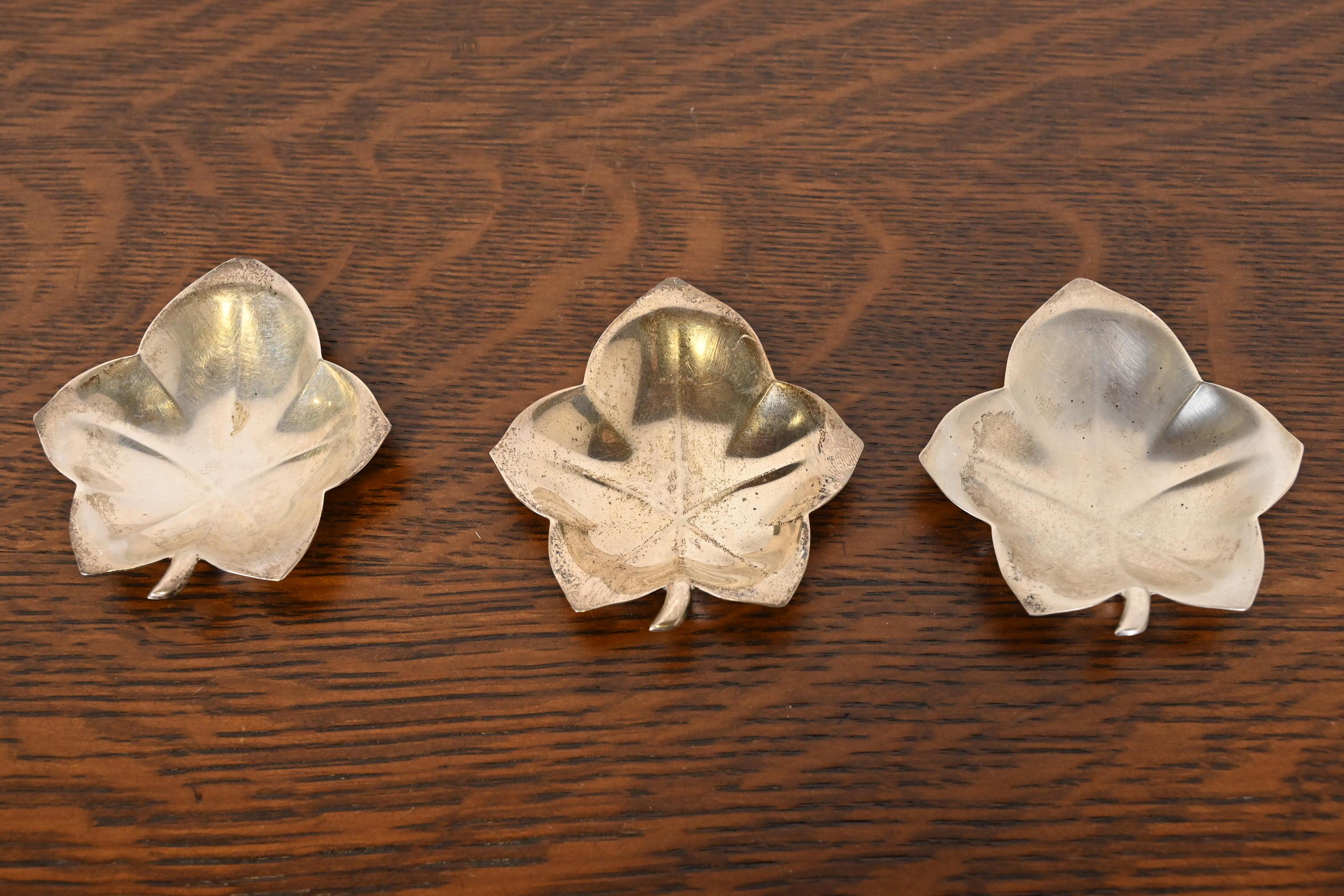 A gorgeous set of three Art Deco period sterling silver leaf-shaped catchall trays or jewelry dishes

By Tiffany & Co. (signed to the underside)

USA, Circa 1940s

Each measures: 3