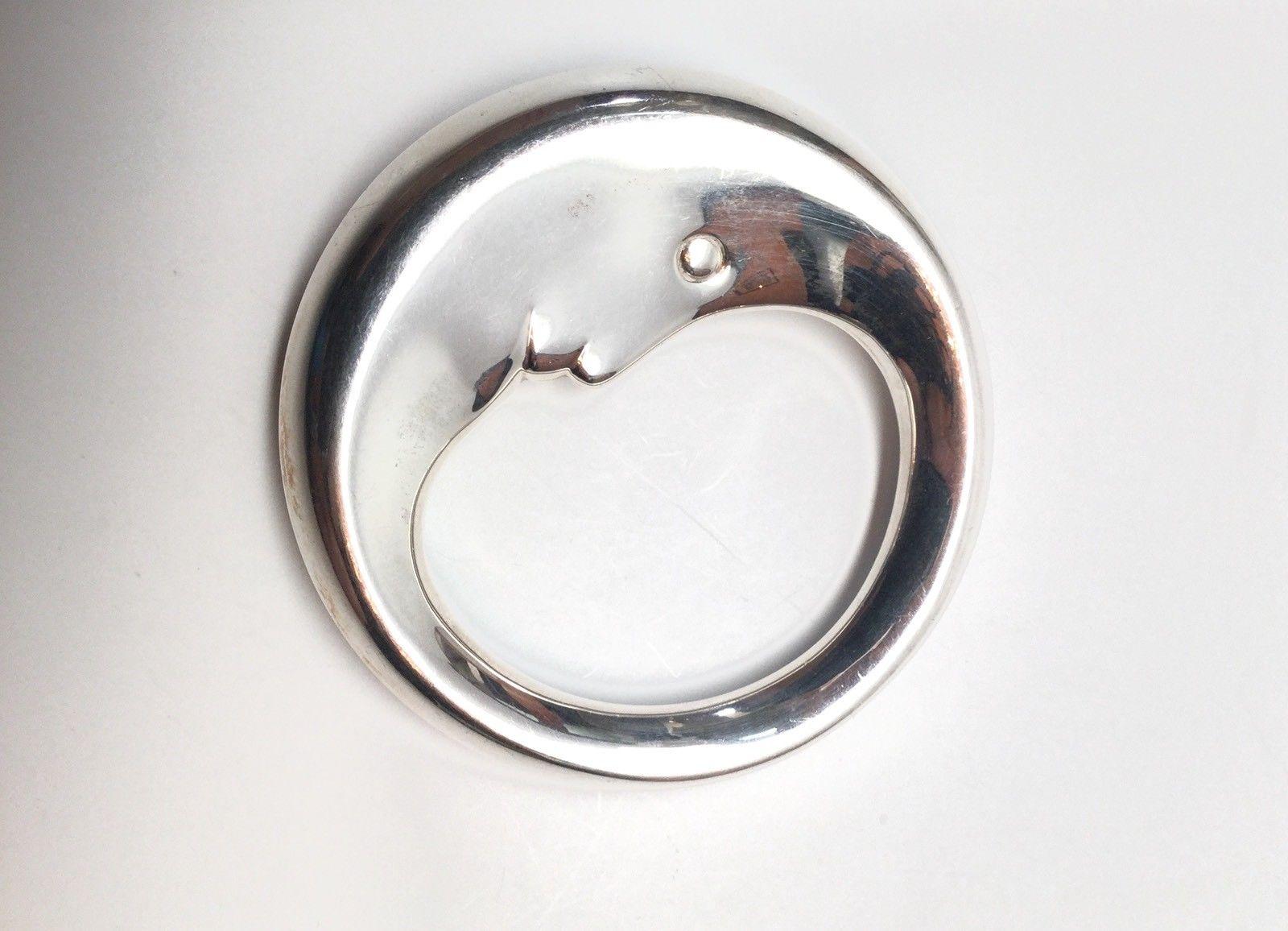 Tiffany & Co. sterling silver man in the moon baby rattle. This is a very special sterling silver man in the moon baby rattle designed by Tiffany & Co. This is a perfect gift for a baby! Measurements: Approximate 2.5 inches in diameter. Approximate