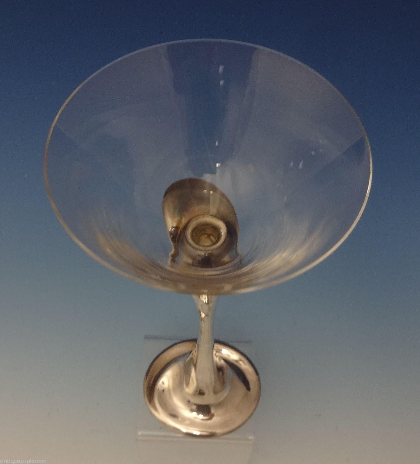 Tiffany & Co.
This elegant sterling silver martini glass was made by Tiffany & Co. and designed by Elsa Peretti. The piece has a glass/crystal top and a sterling stem. It measures a very large 9 1/4 tall, 4 wide, and it weighs 7.0 ozt (with the