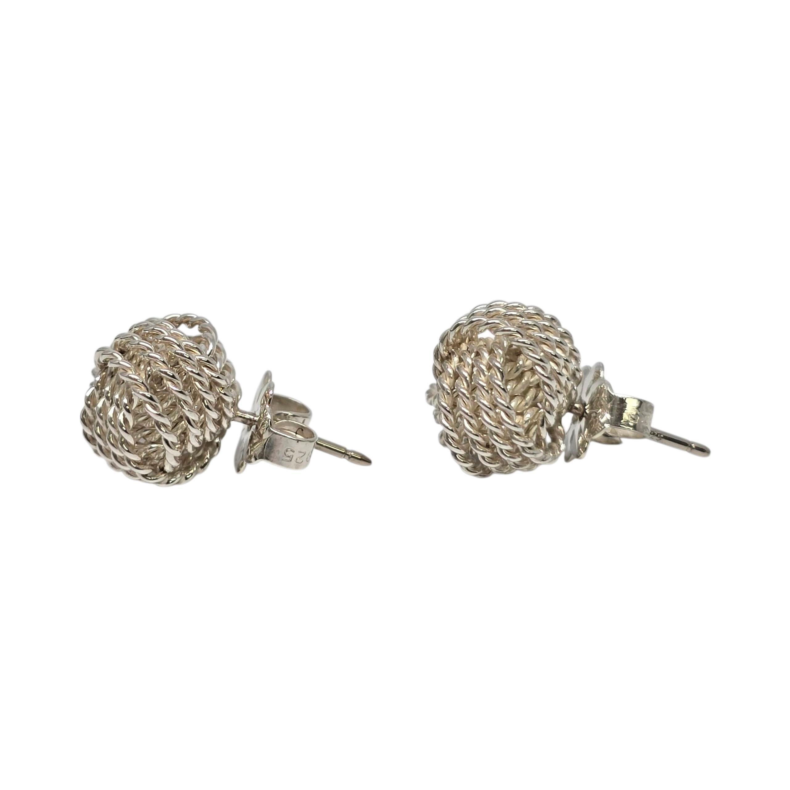 Tiffany & Co Sterling Silver Mesh Knot Earrings.

Authentic Tiffany earrings featuring a knot design. Tiffany & Co box and pouch are not included.

Weighs approx 2.8g, 1.8dwt.

Measures approx 3/8