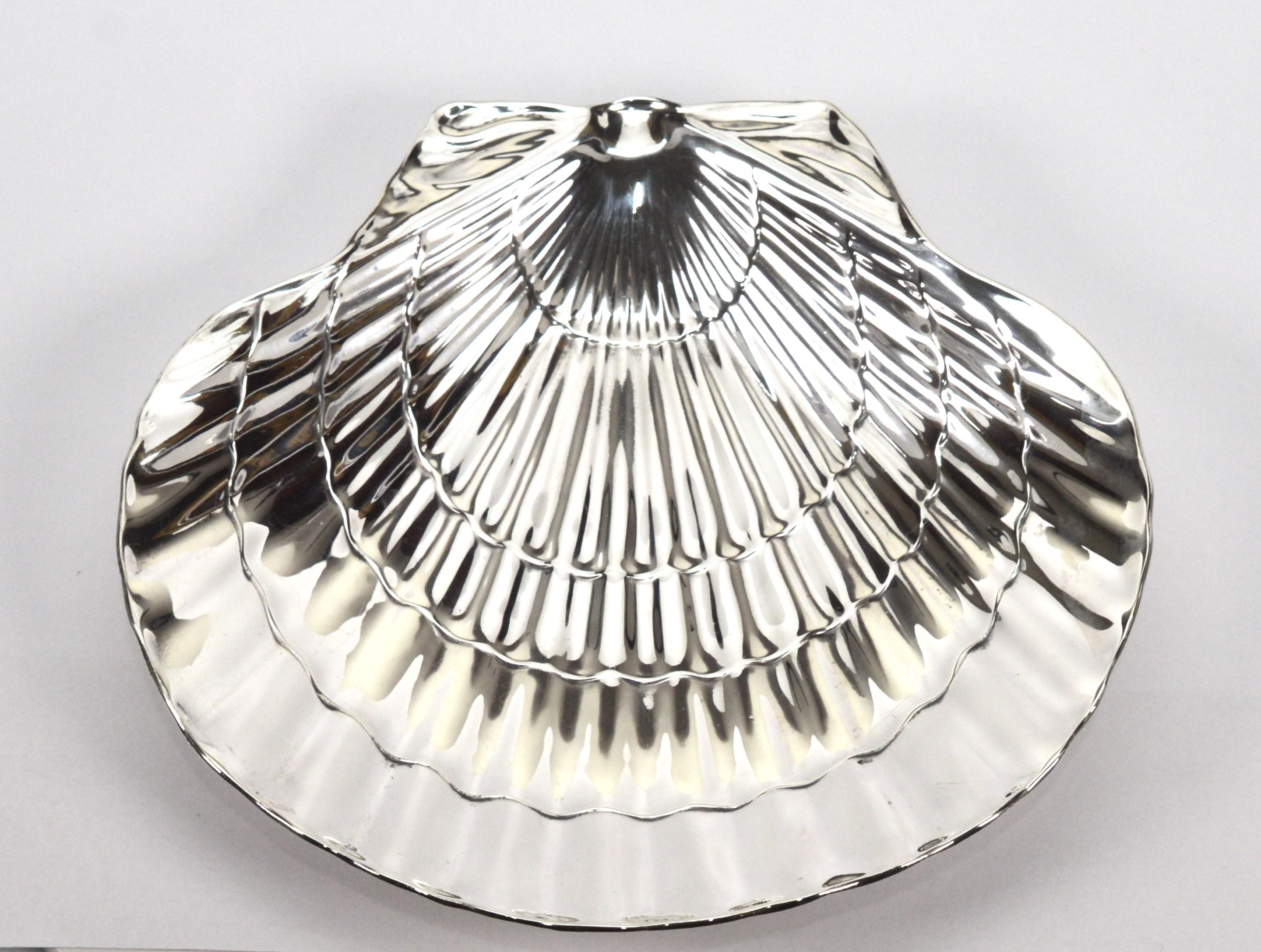 Entertain with vintage Tiffany & Co. In sterling silver, this attractive scallop shell dish has so many practical and decorative uses.  The design was very popular during the mid-20th century and typically used for nuts or candy.  Today, elevate a