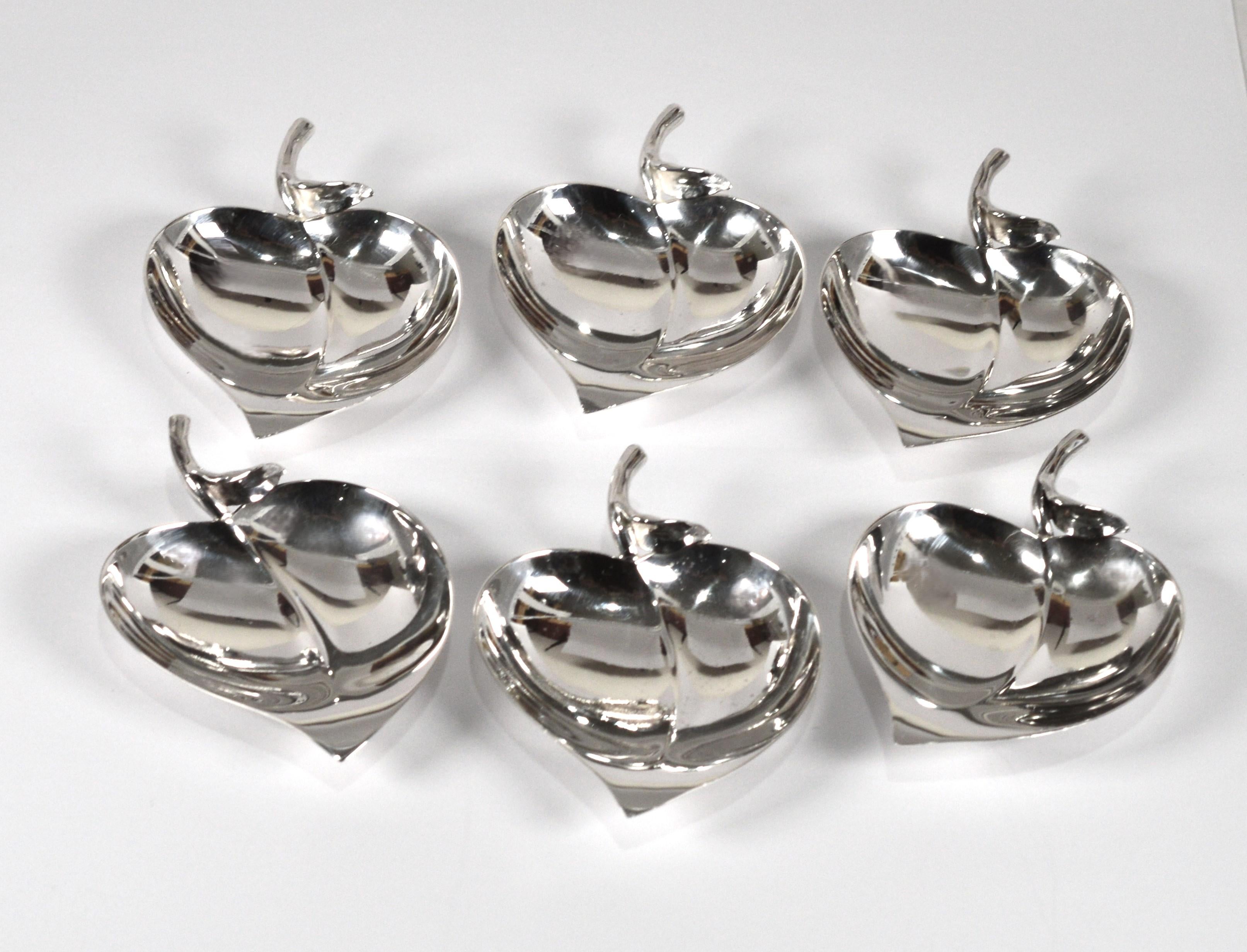 These vintage Tiffany & Co. sterling silver mid-century modern leaf shaped nut or candy will make an elegant impression on any table scape.  In a set of six, these accent dishes can be use for serving or to hold vanity items and jewelry.  Tiffany