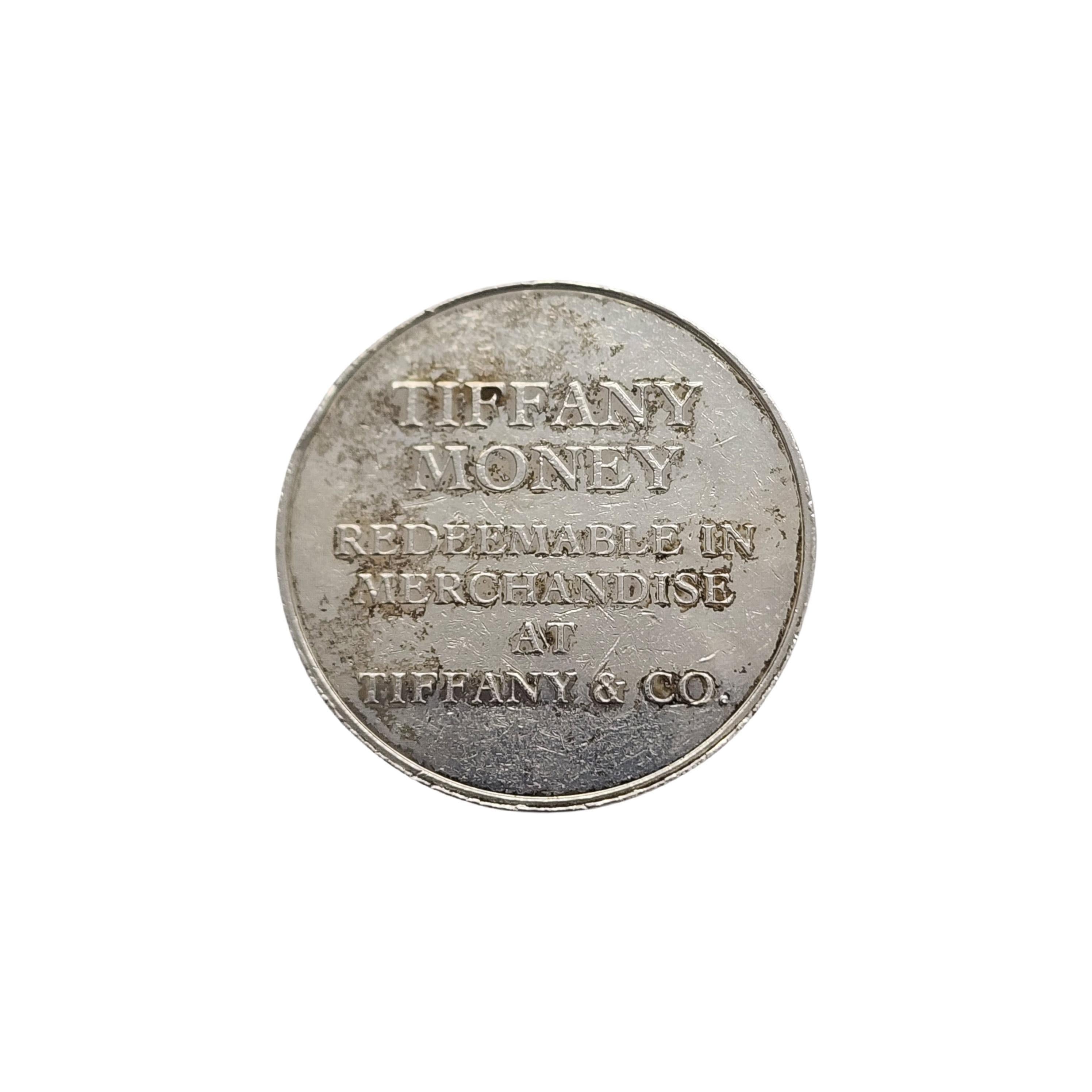 Tiffany & Co sterling silver money coin.

A $25 sterling silver money coin from Tiffany & Co.

Measures approx 1 3/8