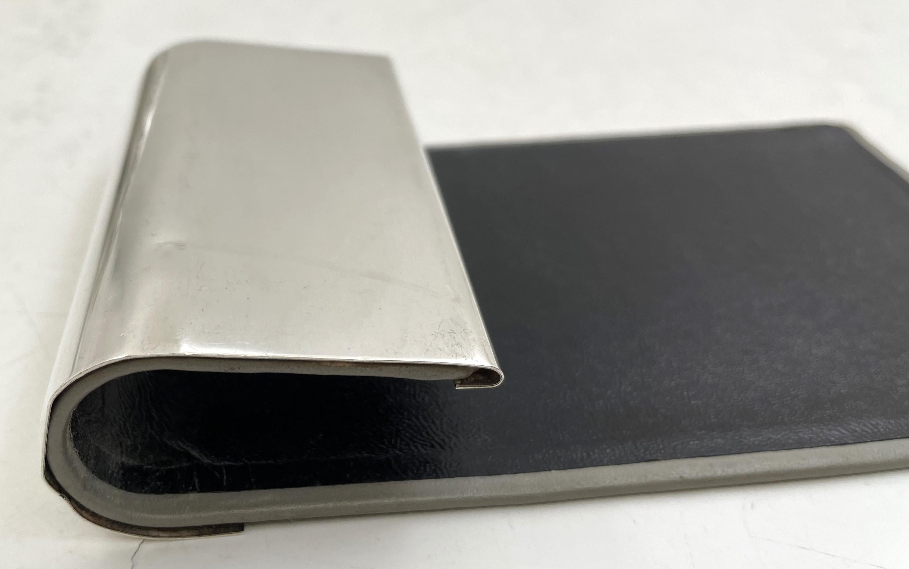Tiffany & Co. sterling silver notepad holder, with leather back. It measures 5 3/4'' in length by 3 1/2'' in width by 1 1/8'' in height, and bears hallmarks as shown.

The legendary Tiffany brand was founded in 1837 by Charles Lewis Tiffany and John