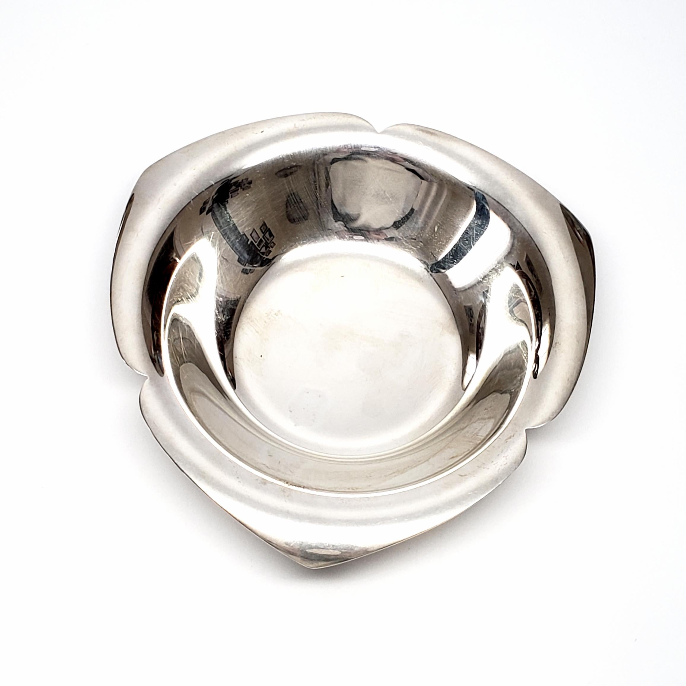 Antique sterling silver Tiffany & Co. nut bowl.

This beautiful bowl can be used for nuts or candy. This bowl has a trefoil-like design, simple lines with rounded points and slightly curled under edges.

Measures approximate 5 1/4