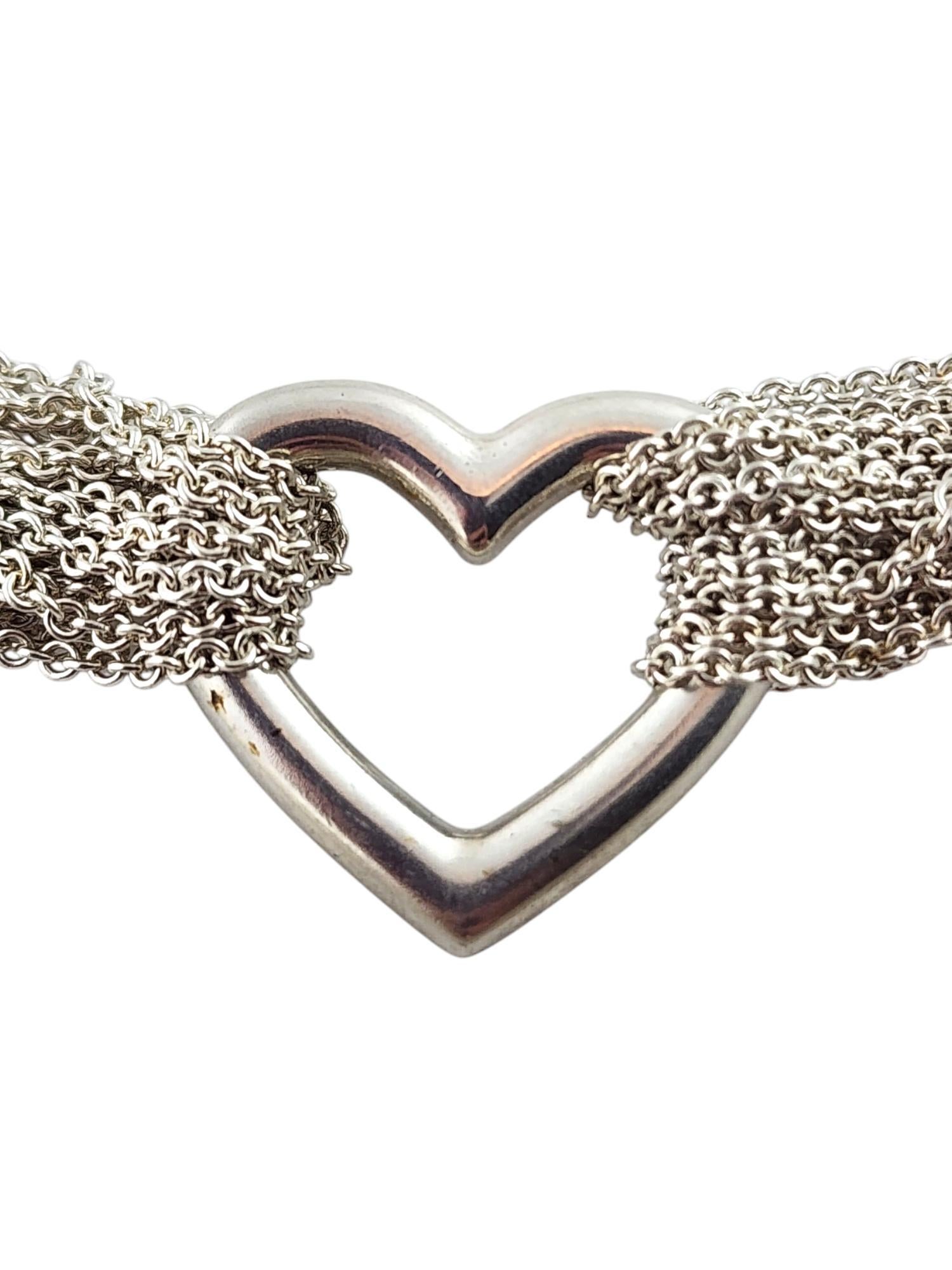 Tiffany & Co Sterling Silver Open Heart Multistrand Mesh Toggle Necklace

This breathtaking piece by amazing designer Tiffany & Co features an open-heart pendant held together by a multistrand mesh necklace with a toggle piece for easy