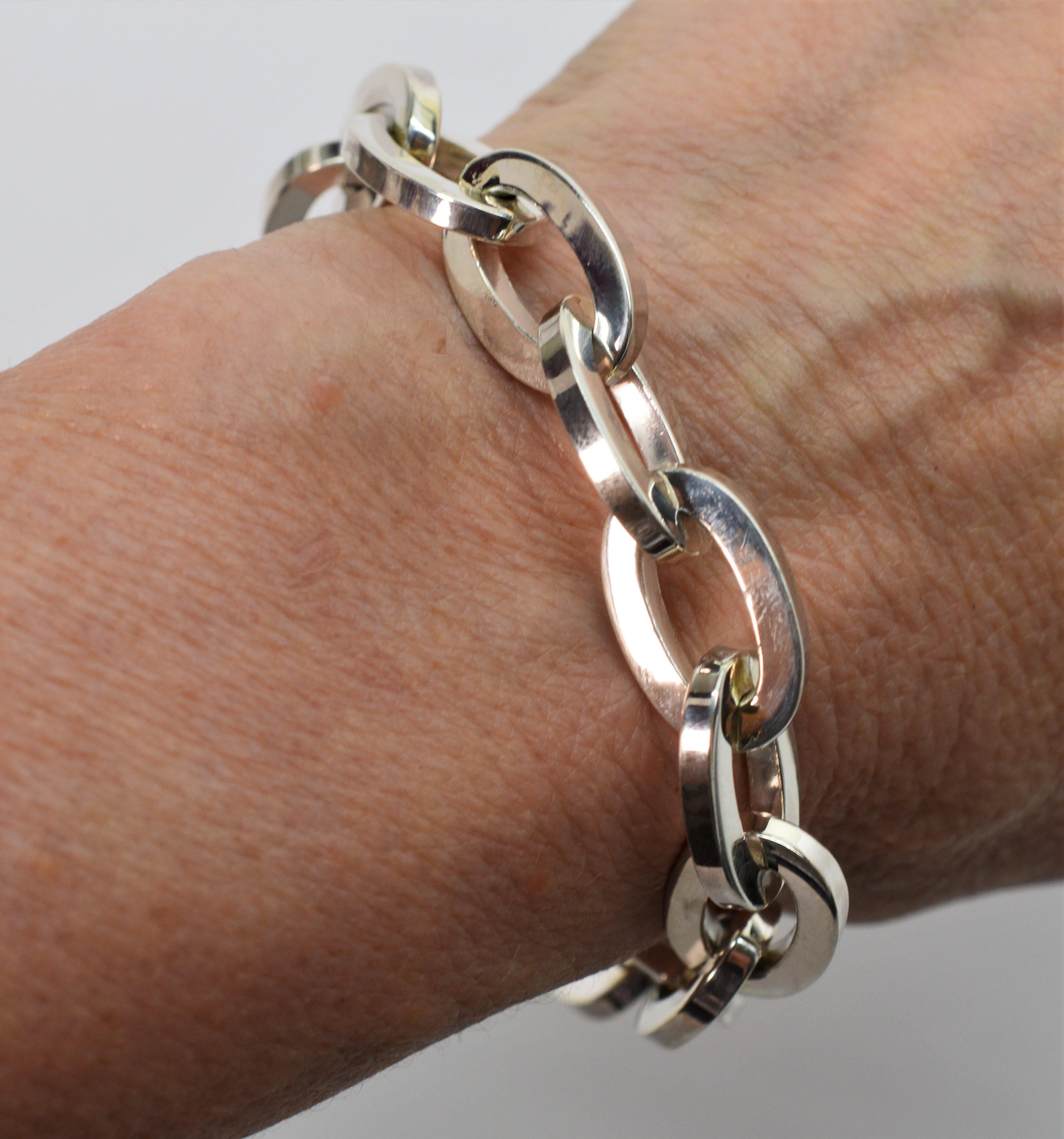 Vintage Tiffany & Co. circa 1960's and made for T&C in occupied West Germany, sterling silver oblong links wrap the wrist to create this dramatic retro style T & Co. Chain Link Bracelet. The unique bypass link clasp gives this piece a fluid and
