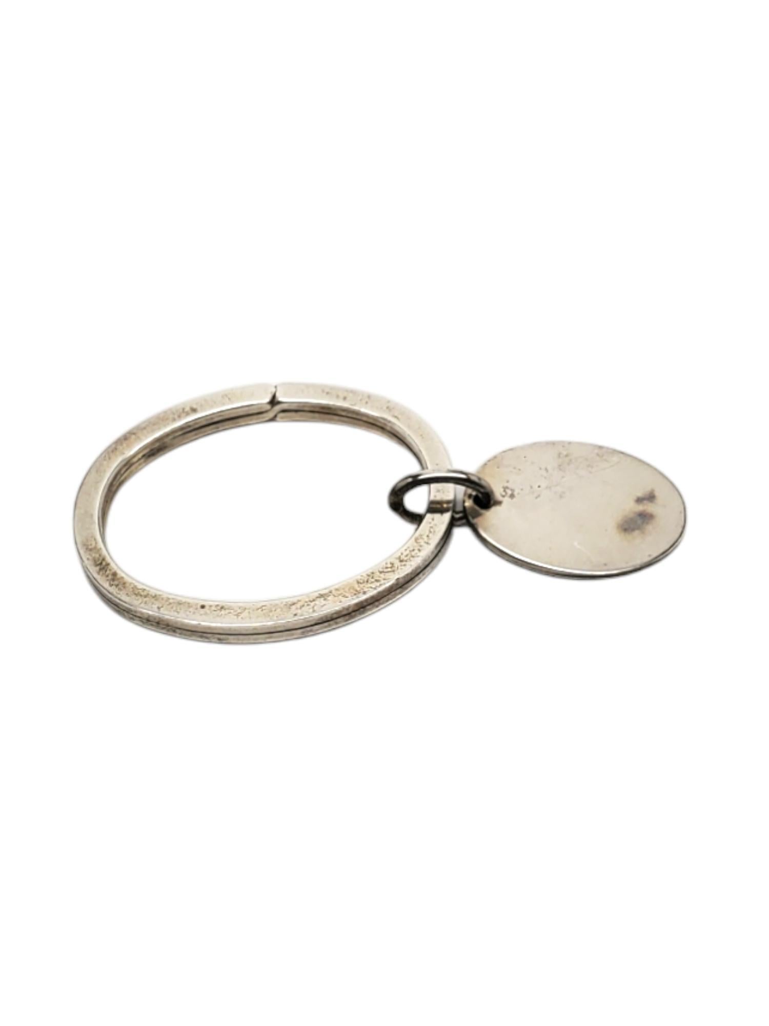 Tiffany & Co. Sterling Silver Oval Key Ring -

This vintage key ring with oval tag in classic sterling silver by Tiffany & Co.

Size: 61.67 mm x 28.41 mm

Stamped: TIFFANY & CO. 925

Weigh: 11.7 dwt / 7.6 gr.

Has not been polished

Will come