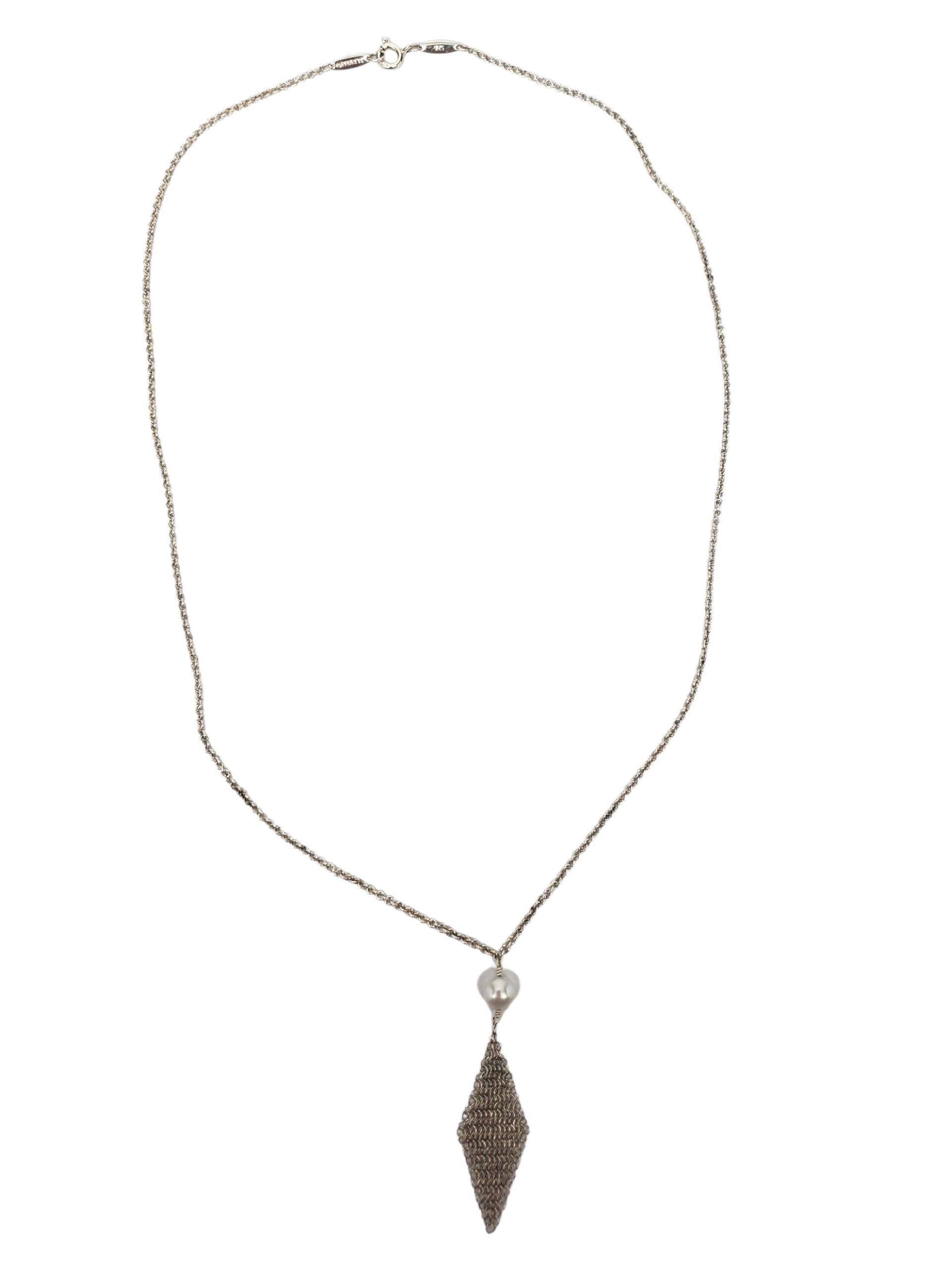 Tiffany & Co. Collana con ciondolo con perle e nappe in maglia d'argento - A. Silver

Questo delizioso esemplare in argento Tiffany & Co. La collana con ciondolo di Elsa Peretti è caratterizzata da una luminosa perla coltivata da 5 mm e da una