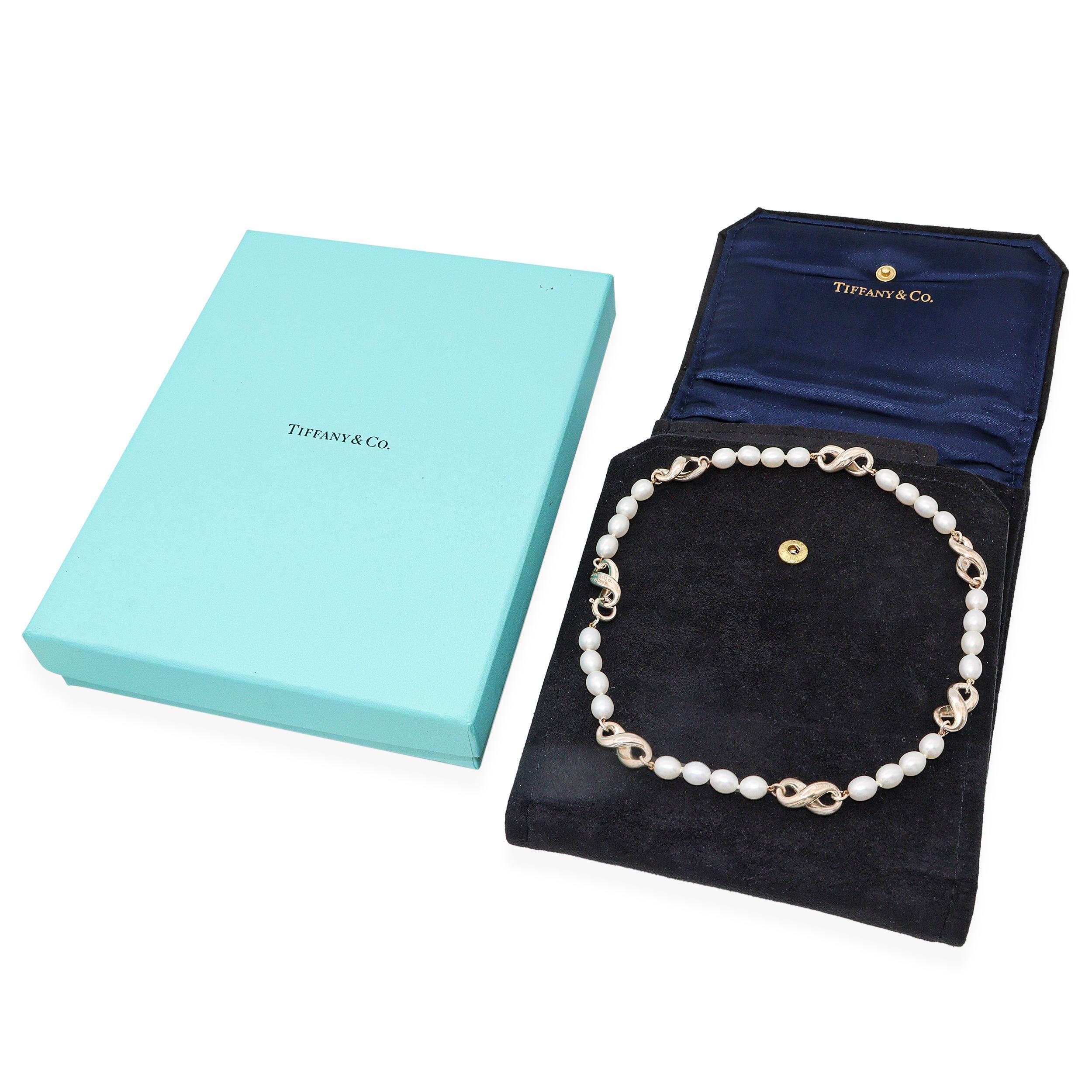 Graceful and symbolic, this Tiffany & Co. necklace features a delicate strand of luminous cultured pearls punctuated by polished sterling silver infinity links. The infinity motif—representing eternal love and timeless connection—is beautifully