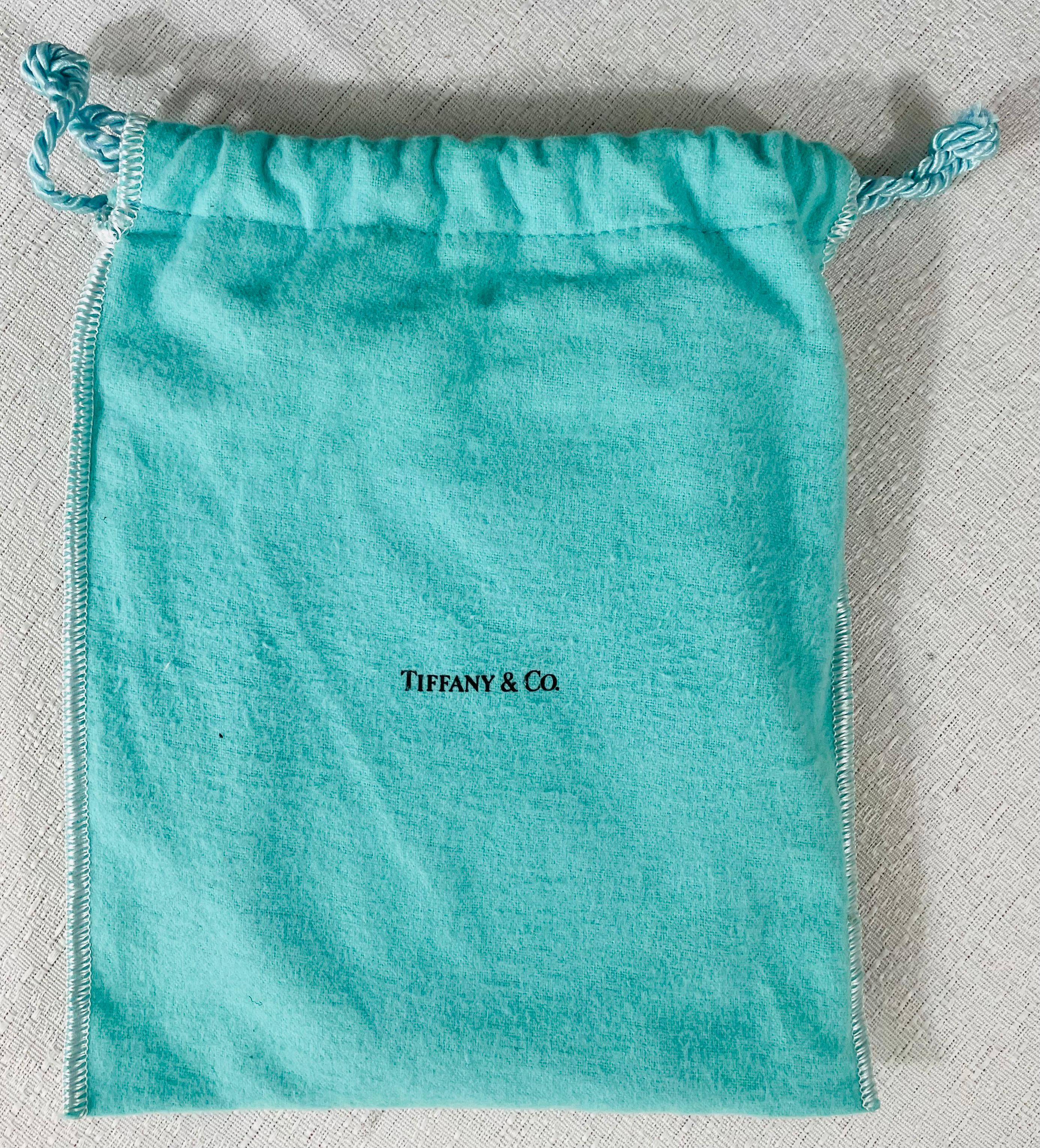 A Tiffany & Co sterling silver picture frame with a convertible car design. The frame is stamped Tiffany & Co .925 in the bottom and is made in Spain. The frame comes with the original blue Pouch. 

Dimensions: 5.25