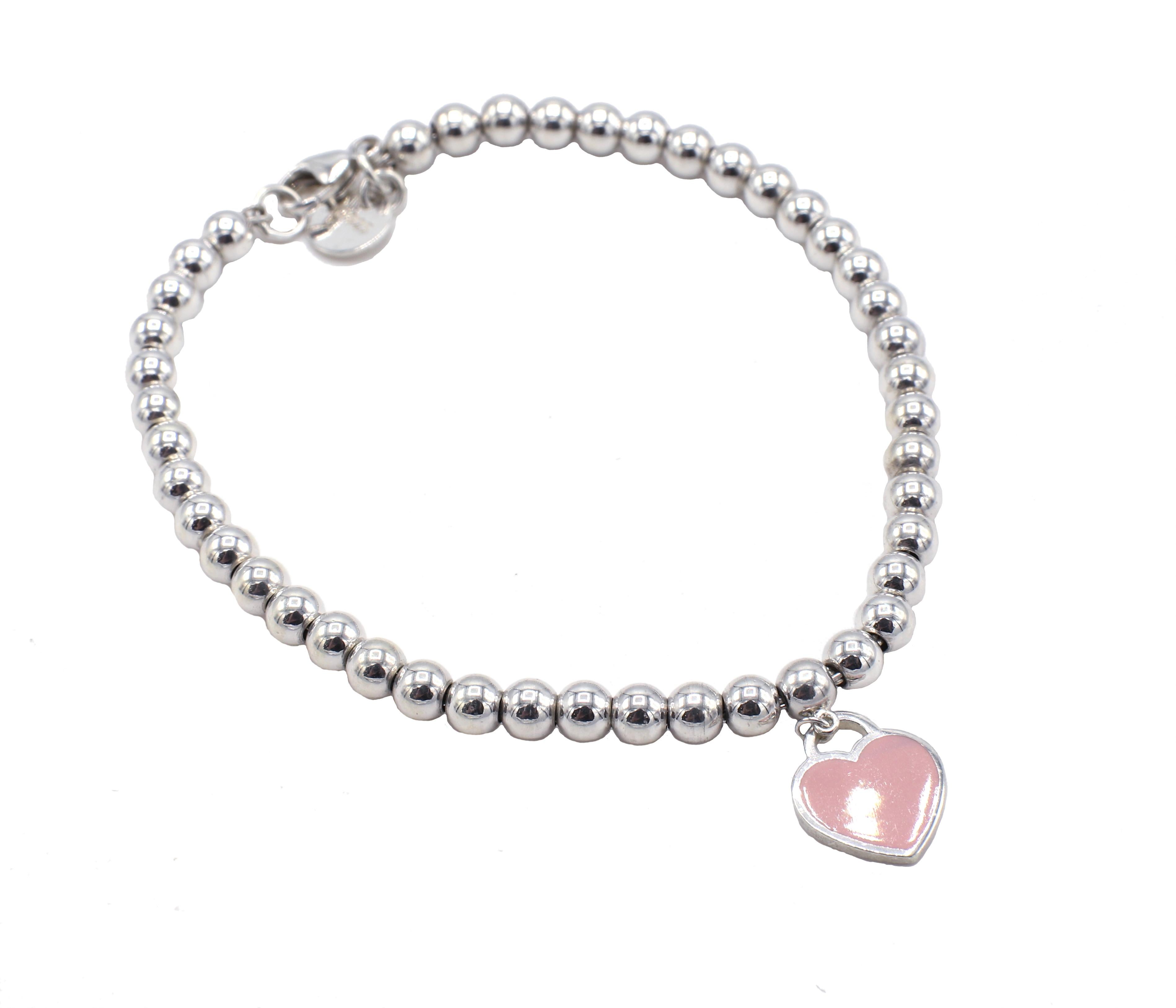 Tiffany & Co. Sterling Silver Pink Enamel Heart Return to Tiffany Tag Bead Bracelet

Metal: Sterling silver 925
Weight: 5.81 grams
Length: 6.75 inches
Width: 4mm
Heart charm: 10 x 11mm
Signed: 