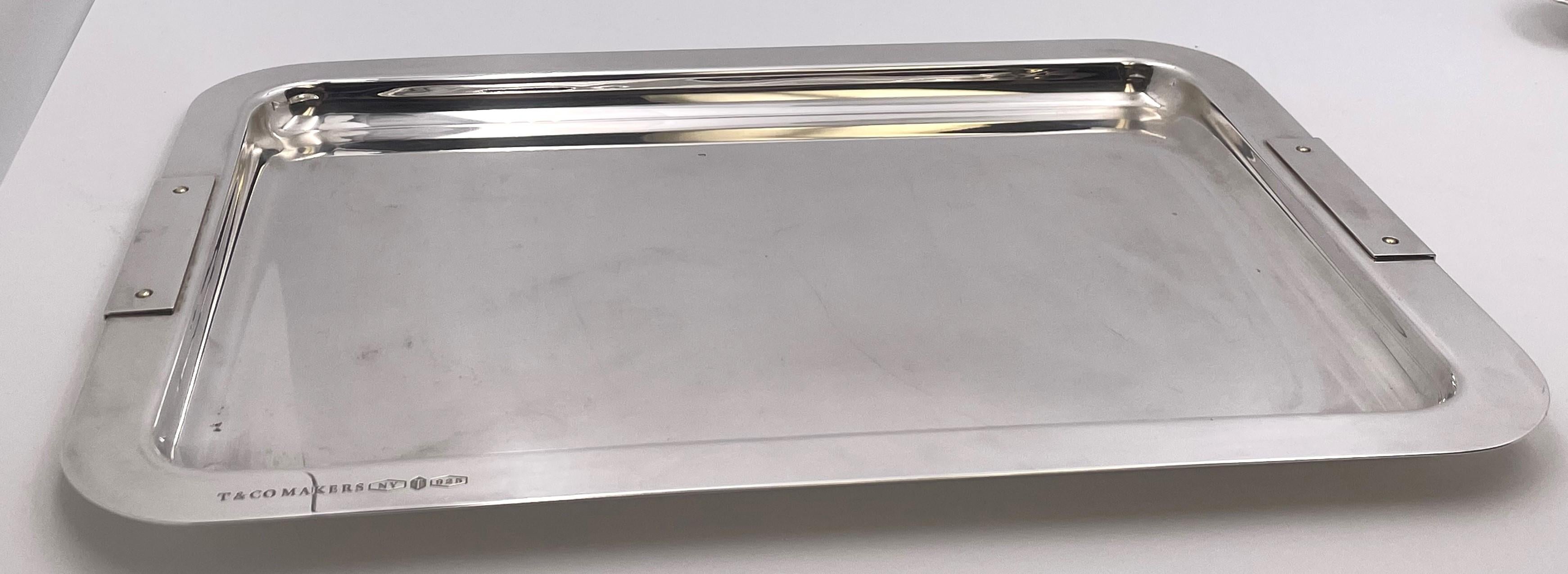 Tiffany & Co. rare sterling silver bar tray, made in Italy in the 20th century, and in Mid-Century Modern style in an elegant, geometric design, the rim showcasing applied motifs. It measures 14 3/4'' in length by 10 7/8'' in width by 3/4'' in