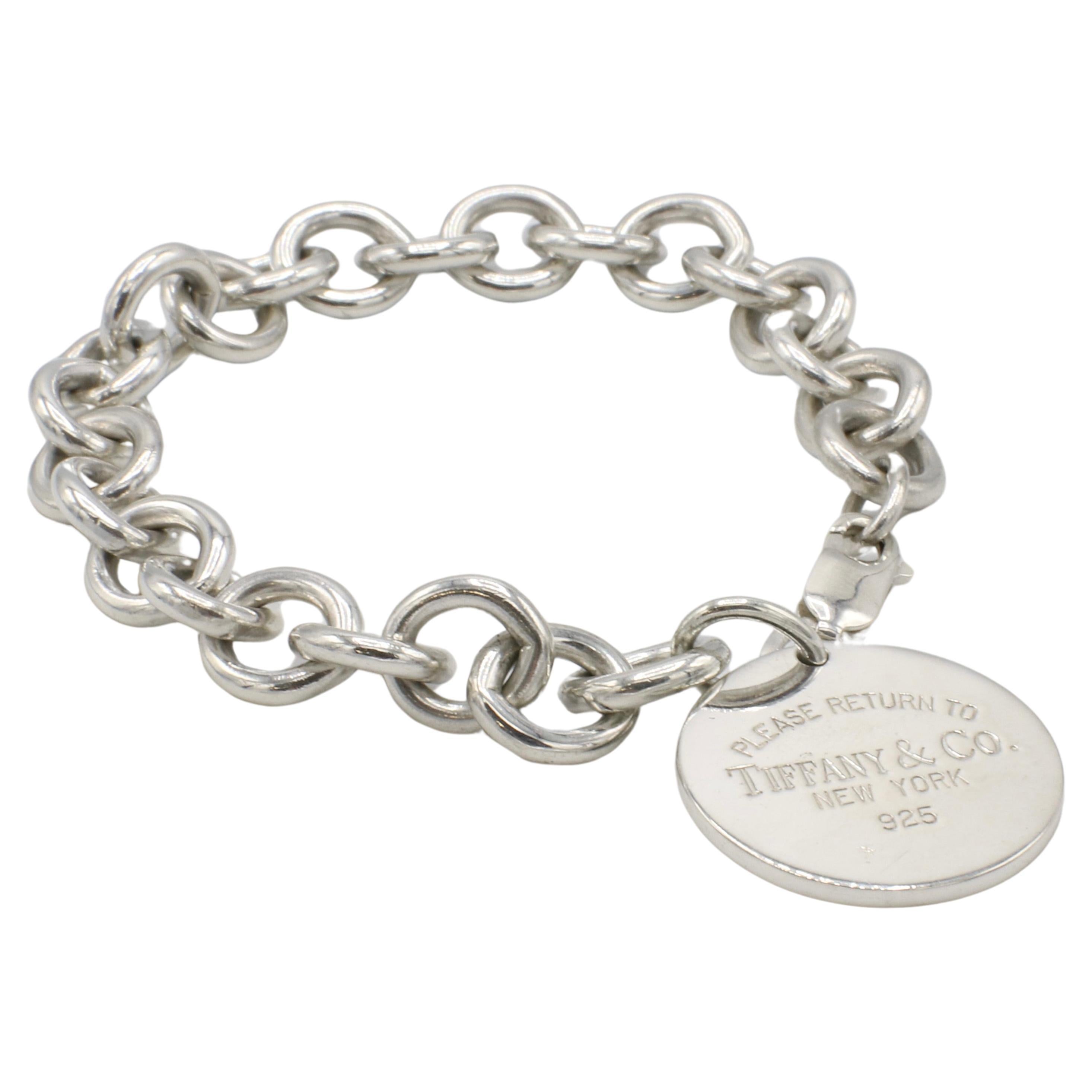 Tiffany & Co. Sterling Silver Return to Tiffany Circle Charm Link Bracelet 
Metal: Sterling silver 925
Weight: 36.27 grams
Length: 7 inches
Charm: Please Return to Tiffany & Co. New York 925, 24mm

