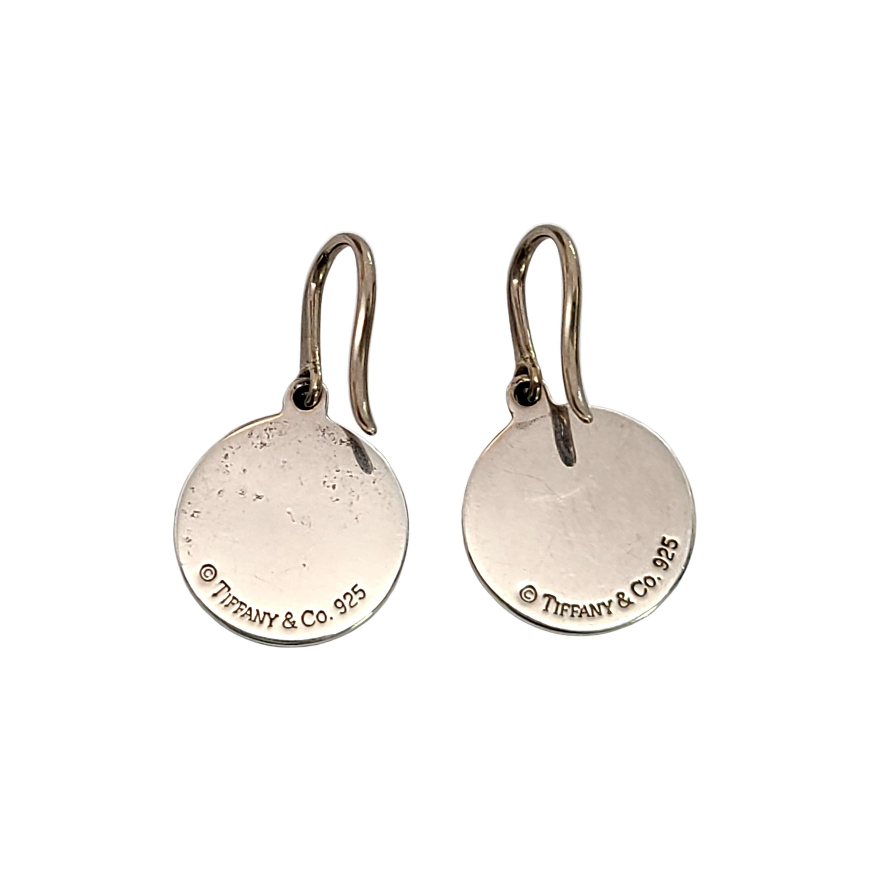Tiffany & Co sterling silver Return To Tiffany dangle disc earrings.

Authentic Tiffany earrings with a disc dangle design that says 