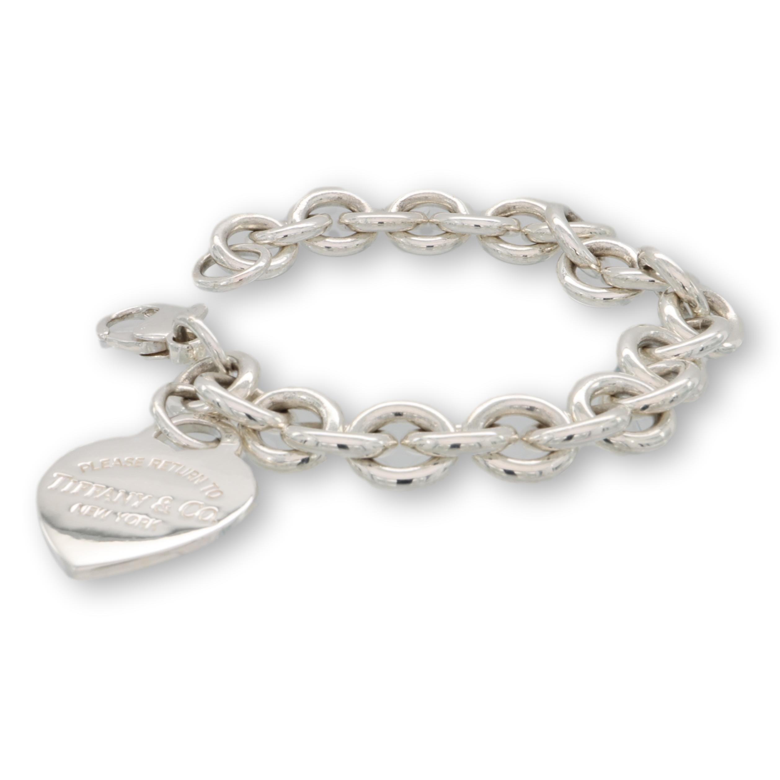 Tiffany & Co. link bracelet from the Return to Tiffany collection finely crafted in fine Sterling Silver featuring a heart Tiffany logo charm hanging off a 7