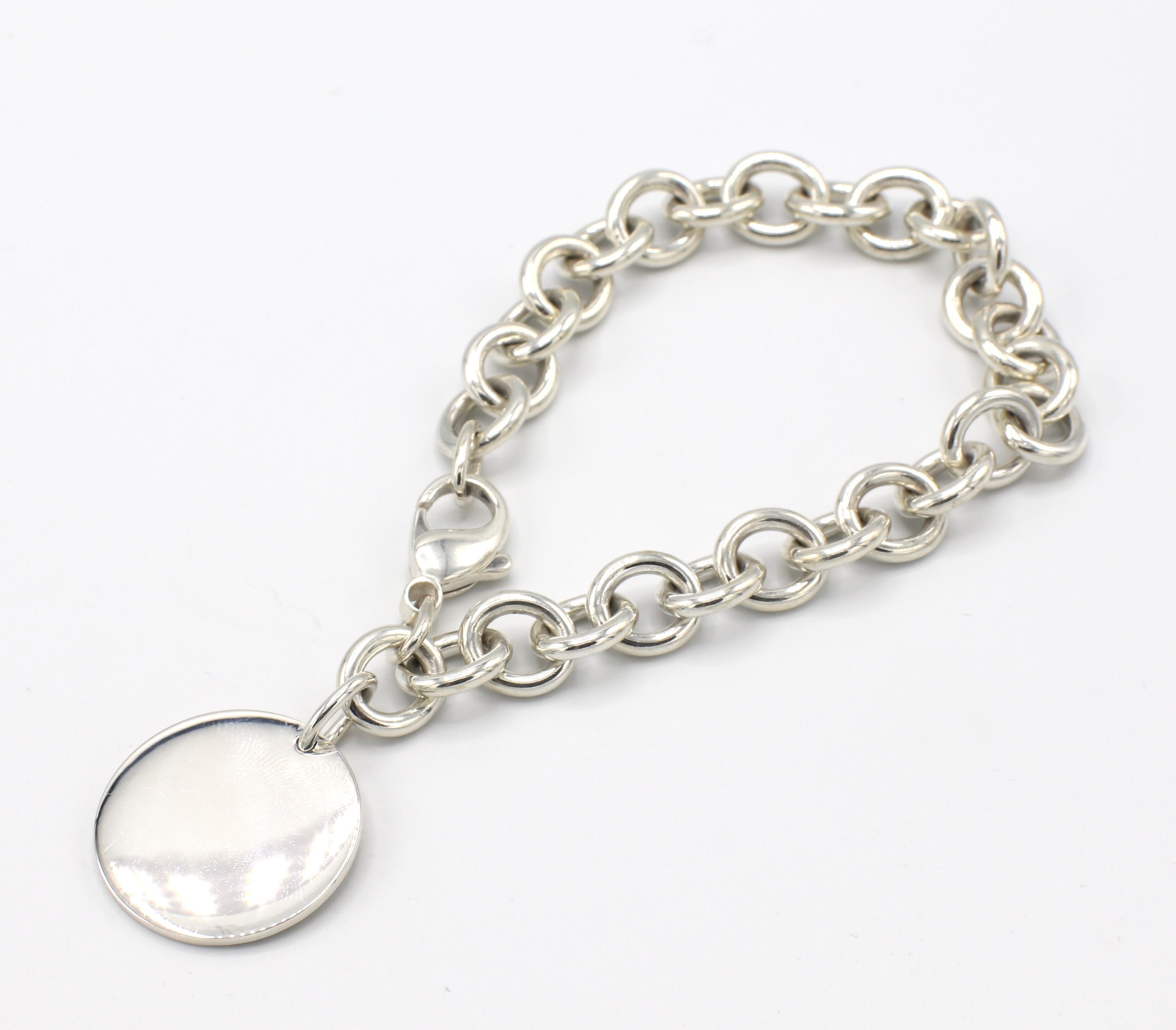 Tiffany & Co. Sterling Silver Return to Tiffany Round Charm Tag Link Bracelet 
Metal: Sterling silver
Weight: 37.8 grams
Length: 8 inches
Charm diameter: 24mm
Signed: Please Return To Tiffany & Co. New York 925
