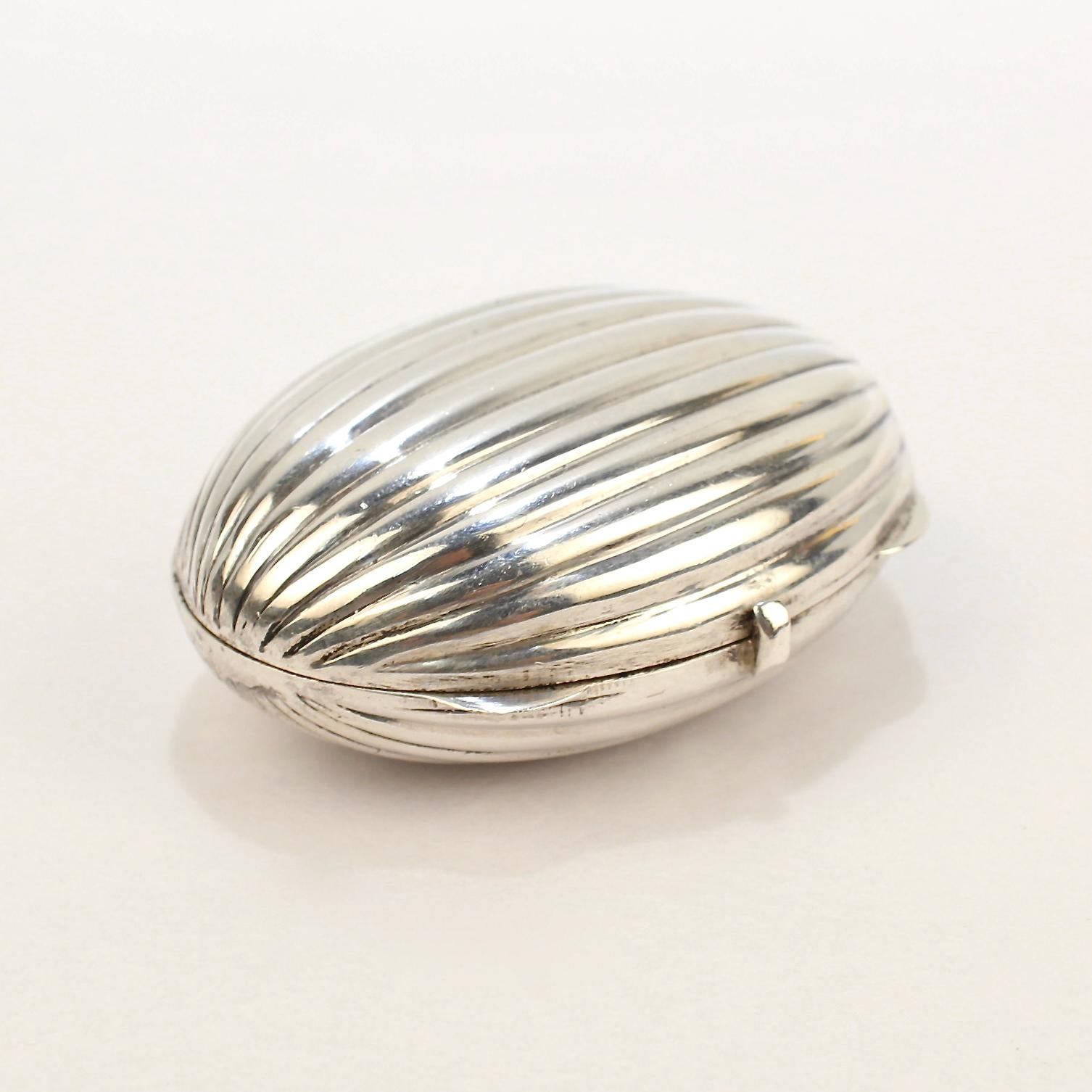 A very fine Tiffany & Co. oval pill box.

In sterling silver with melon-type ribs to the top and bottom.

Provenance: 
From the collection of the legendary interior decorator - Mario Buatta.

Date:
20th Century

Overall Condition:
It is in overall
