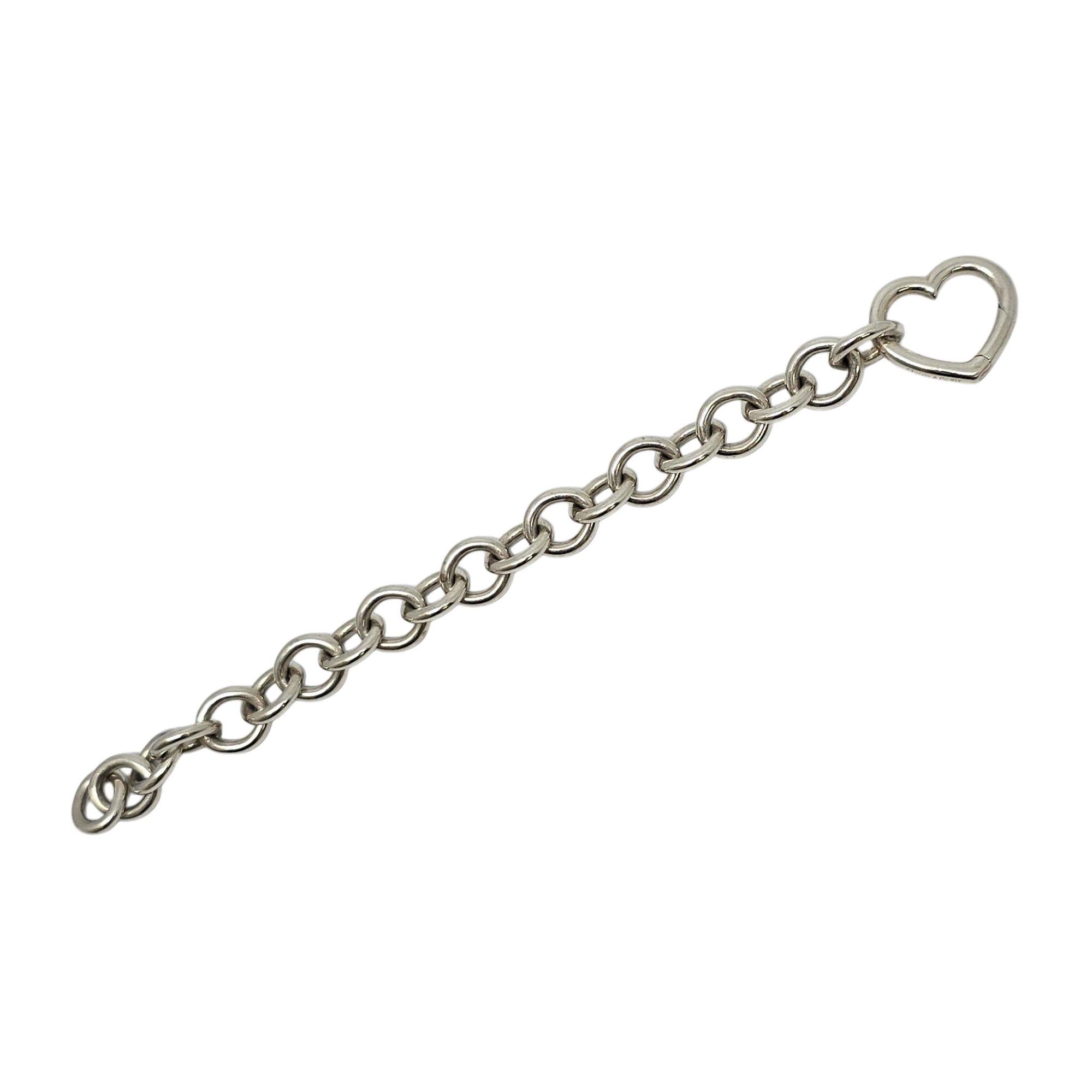 Sterling silver rolo link heart clasp bracelet by Tiffany & Co.

This Tiffany & Co bracelet features smooth round links and a heart shaped clasp. Tiffany & Co box and pouch are not included.

Measures approx 6 1/4