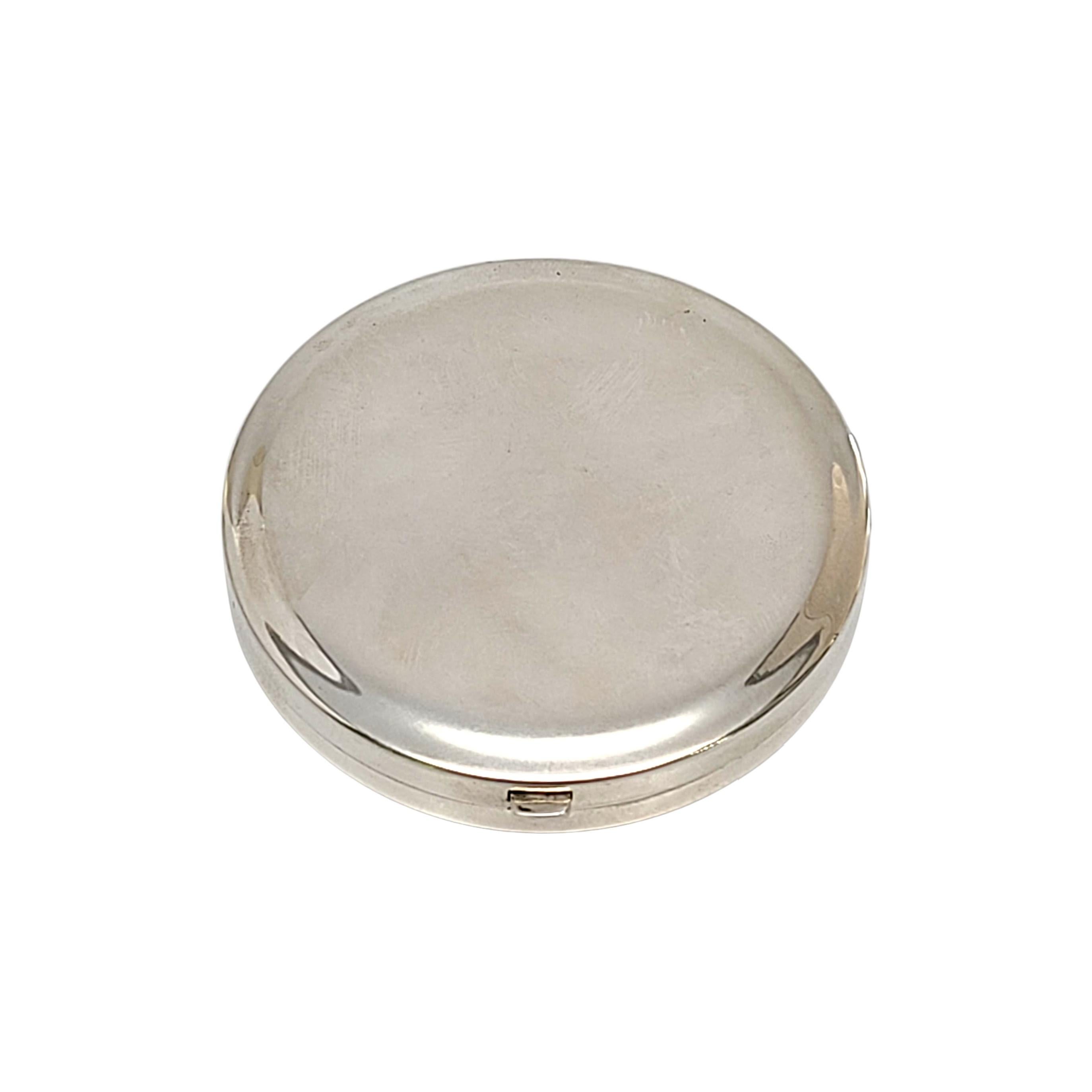 Sterling silver round mirror compact pendant by Tiffany & Co.

Beautiful simple, classic and timeless polished design. Push button release opens to a mirrored inside lid, includes powder puff and screen. Tiffany & Co box and pouch not included.

Ni
