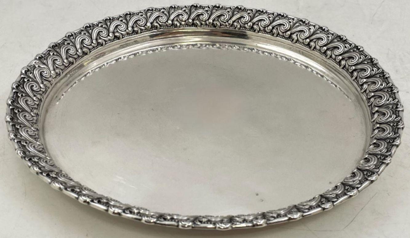 Tiffany & Co. sterling silver smoking set, in pattern number 14095 from 1899, beautifully adorned with wave-style motifs, consisting of:

a round tray measuring 8 1/2'' in diameter by 3/4'' in height

a cup, measuring 3'' in height by 2 1/3'' in
