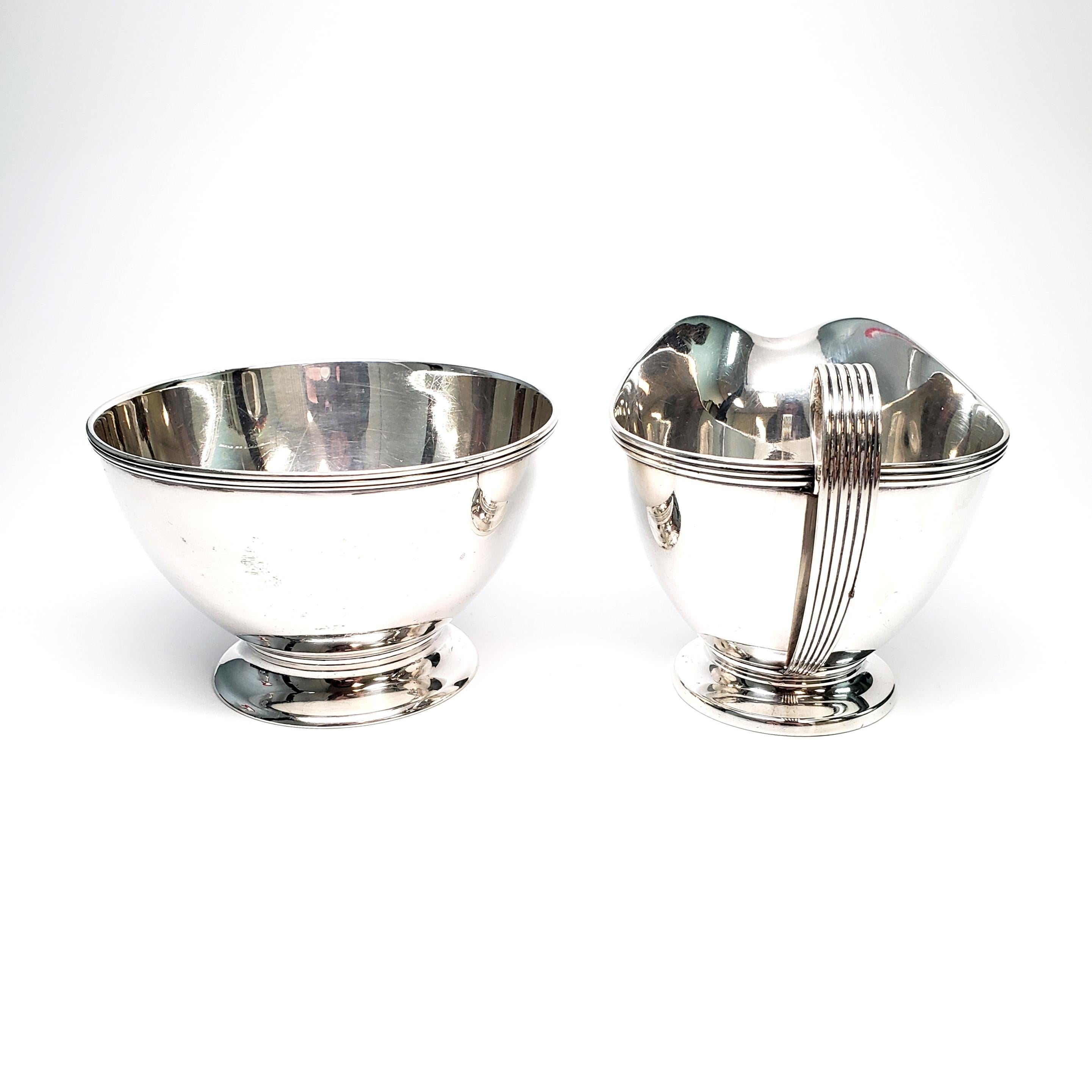 Vintage sterling silver creamer and sugar bowl set from Tiffany & Co.

The set is a timeless, simple and elegant design. Marked with an M, representing manufacture between 1907-1947 under the directorship of John C. Moore II.

The creamer