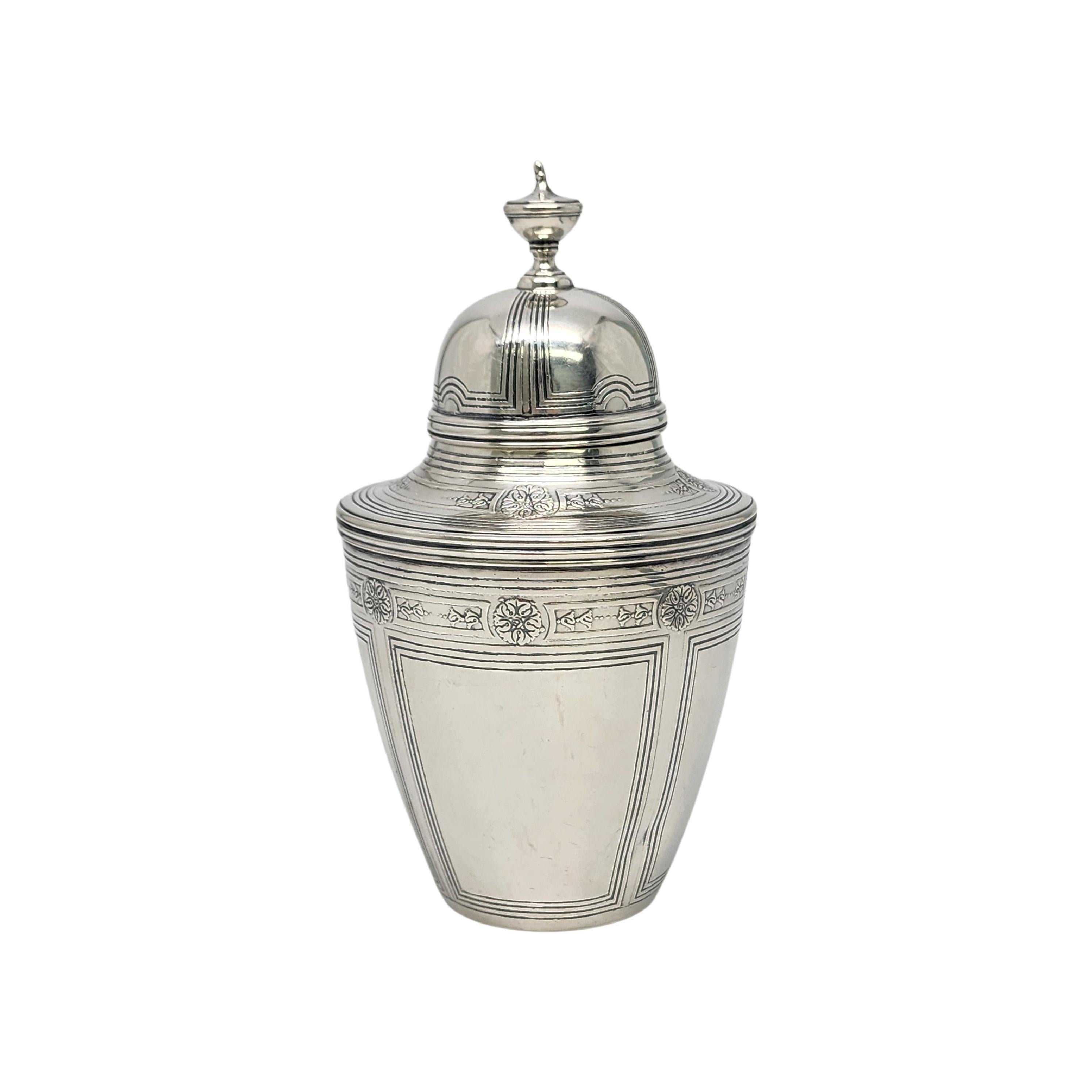 Sterling silver tea caddy by Tiffany & Co with monogram.

Monogram appears to be MSC

This beautiful urn style tea caddy is done in an Art Deco pattern featuring flowers and lines. Pattern number dates this piece to circa 1910.  Hallmarks date this