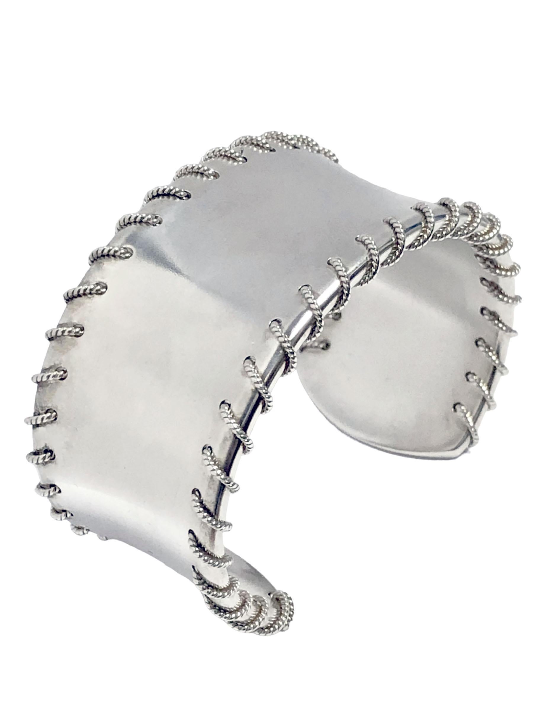 Circa 2001 Tiffany & Company Sterling Silver Cuff Bracelet with threaded Rope Design. Measuring 1 1/4 Inch wide with an opening of 1 inch that is adjustable so this bracelet will fit most any wrist. Comes in original Tiffany pouch.