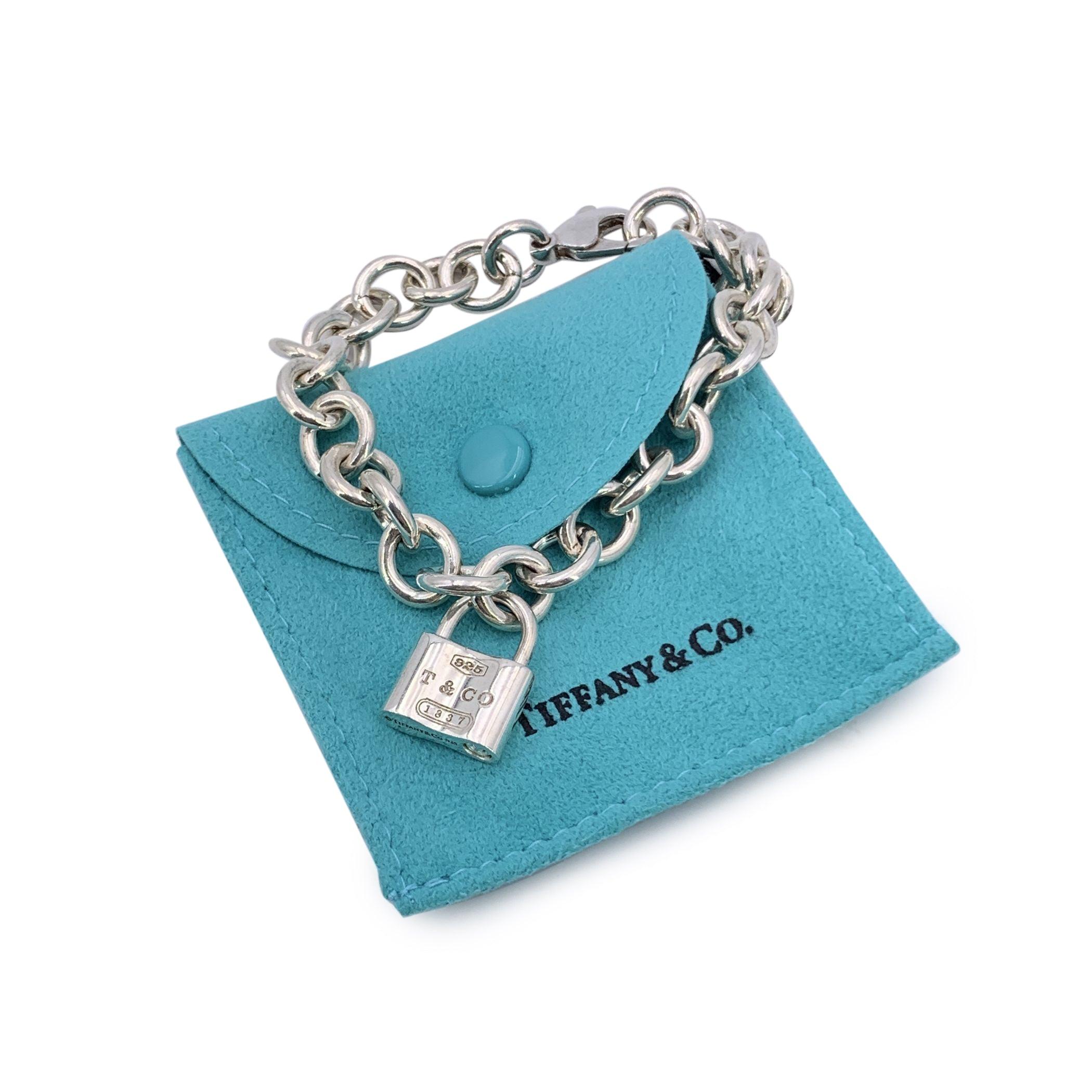This beautiful sterling silver chain bracelet by Tiffany & Co. is a perfect blend of elegance and history, featuring the iconic Tiffany 1837 padlock pendant. The padlock proudly displays the year Tiffany was founded, a subtle yet powerful nod to the